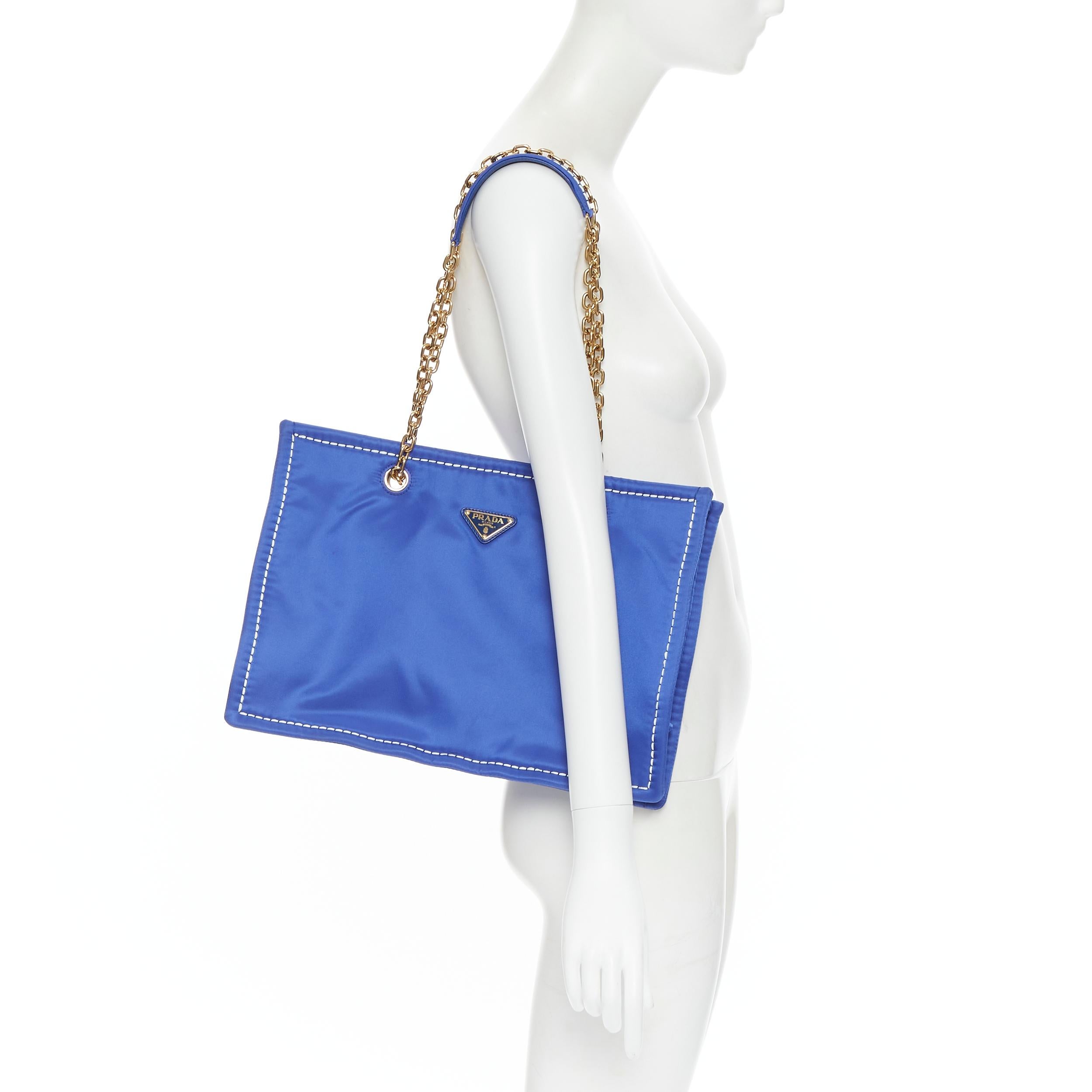 new PRADA cobalt blue Tessuto Nylon overstitch triangle logo gold chain tote bag 
Reference: TGAS/B00755 
Brand: Prada 
Designer: Miuccia Prada 
Model: Tessuto nylon tote 
Material: Nylon Color: Blue 
Pattern: Solid 
Extra Detail: Single zip wall