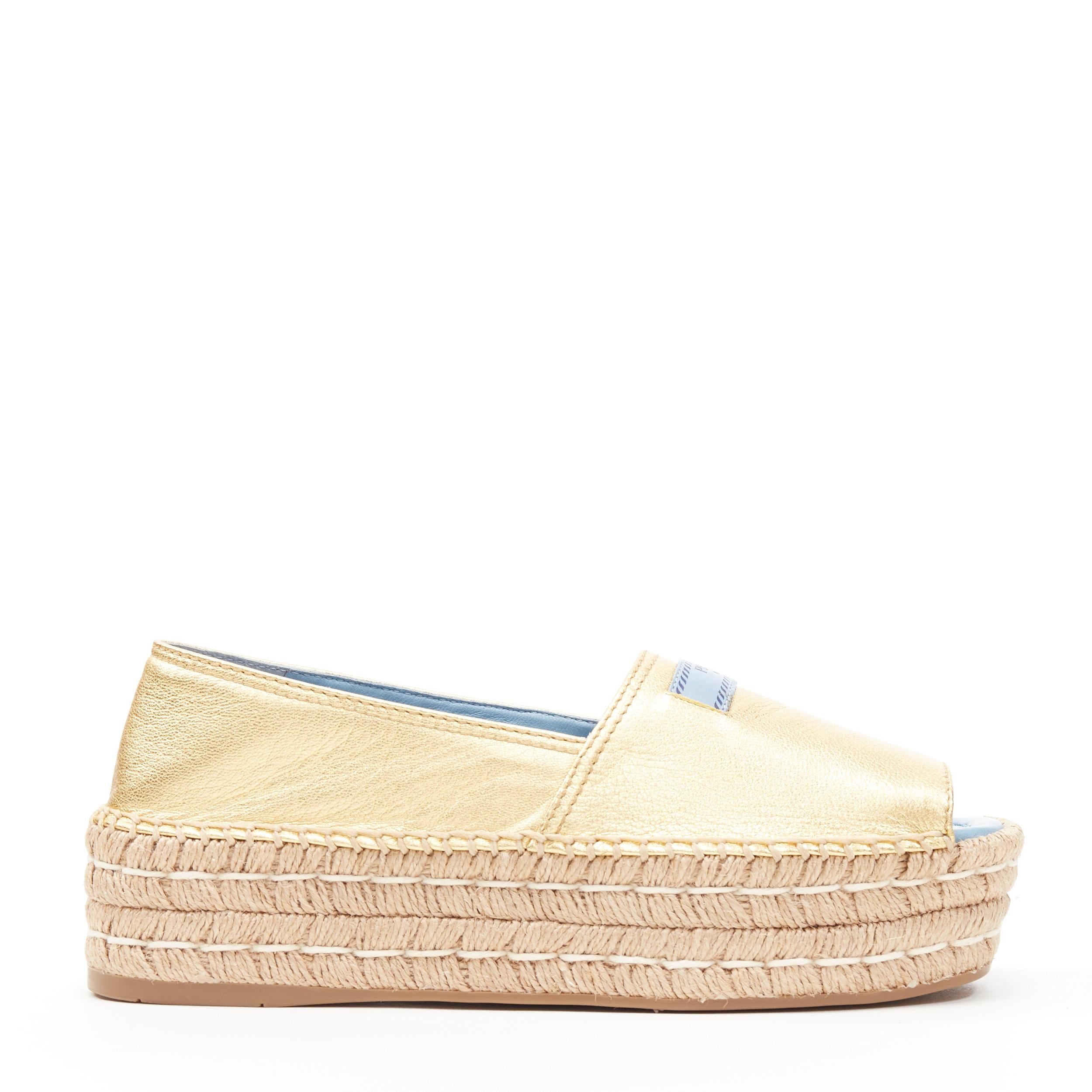 new PRADA gold leather logo peep toe jute platform espadrille shoe EU38.5 
Reference: TGAS/B00343 
Brand: Prada 
Designer: Miuccia Prada 
Model: Platform espadrille 
Material: Leather 
Color: Gold 
Pattern: Solid 
Extra Detail: Signature Prada dual