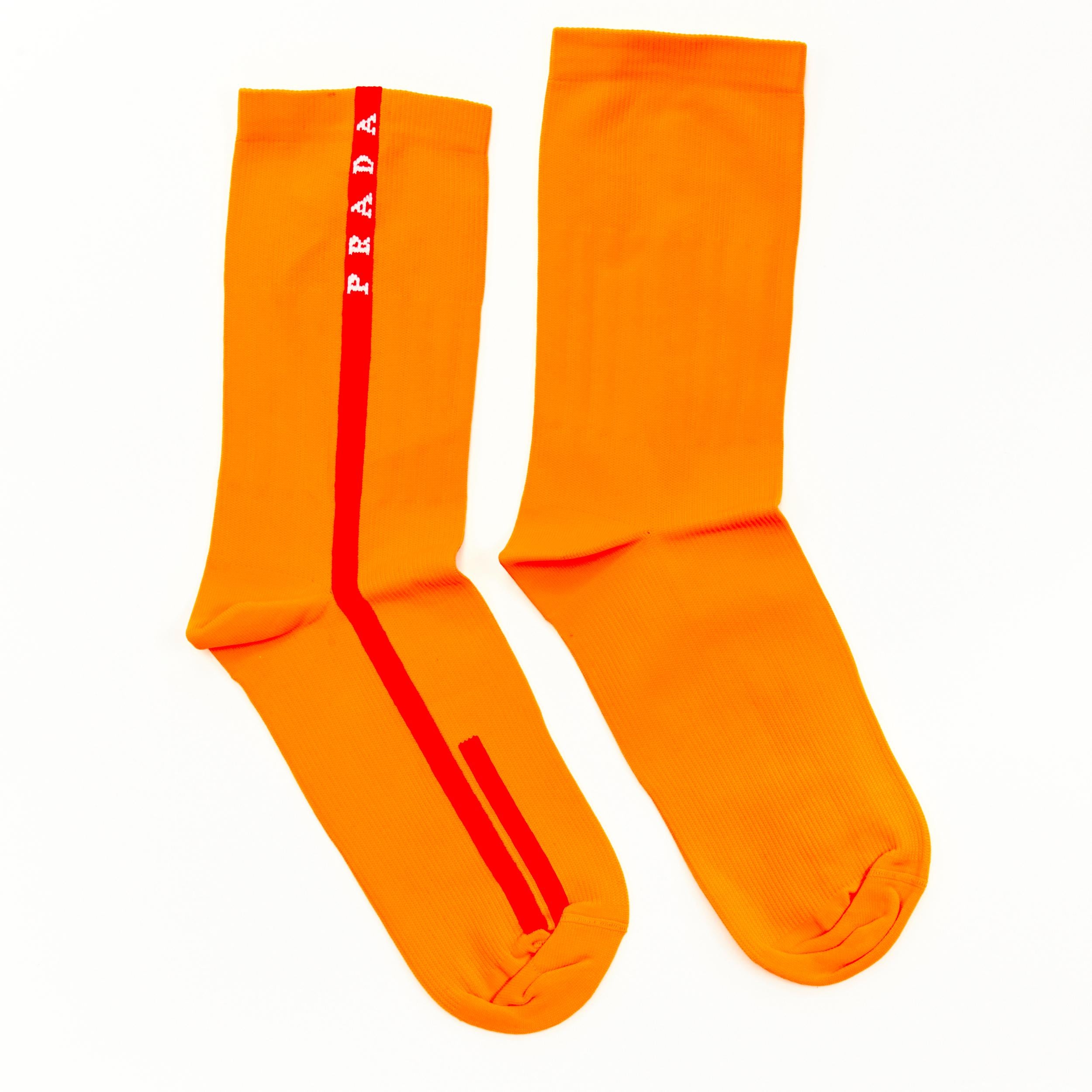 new PRADA Linea Rossa neon orange red line logo cotton socks nylon pouch 
Reference: ANWU/A00101 
Brand: Prada 
Designer: Miuccia Prada 
Material: Cotton 
Color: Orange 
Pattern: Solid 
Extra Detail: Comes with Linea Rossa waterproof zip pouch bag