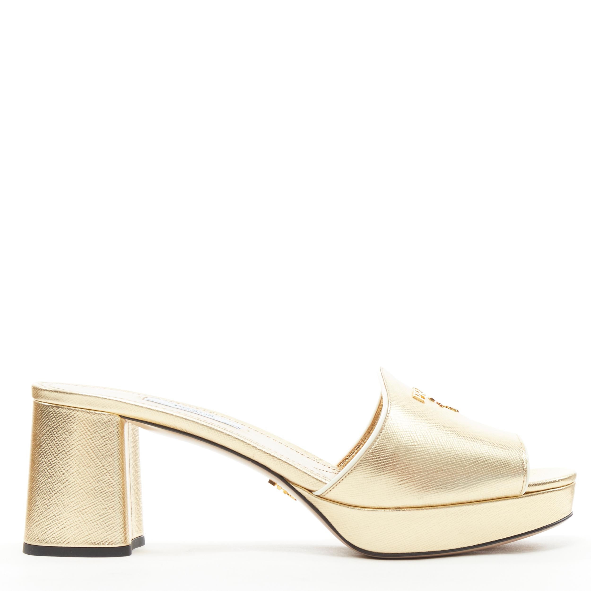 new PRADA metallic gold saffiano leather logo open toe mule clog sandal EU38 
Reference: TGAS/B00651 
Brand: Prada 
Designer: Miuccia Prada 
Model: Saffiano logo mule clogs 
Material: Leather 
Color: Gold 
Pattern: Solid 
Extra Detail: Metallic gold