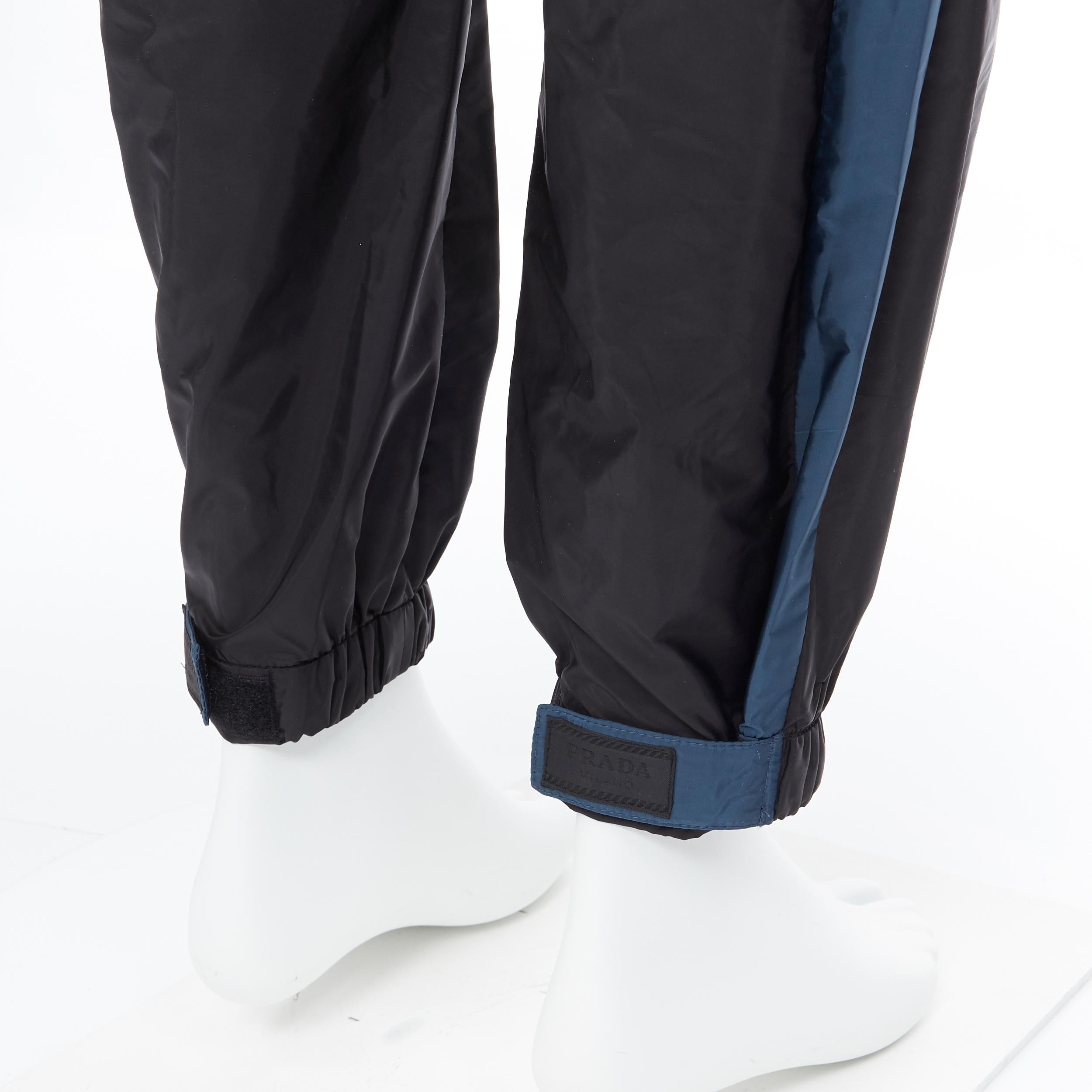 new PRADA Nylon 2018 black blue side stripe toggle gabardine track pants L 
Reference: TGAS/A05730 
Brand: Prada 
Designer: Miuccia Prada 
Collection: 2018 
Material: Nylon 
Color: Black 
Pattern: Solid 
Closure: Zip 
Extra Detail: Elasticated waist