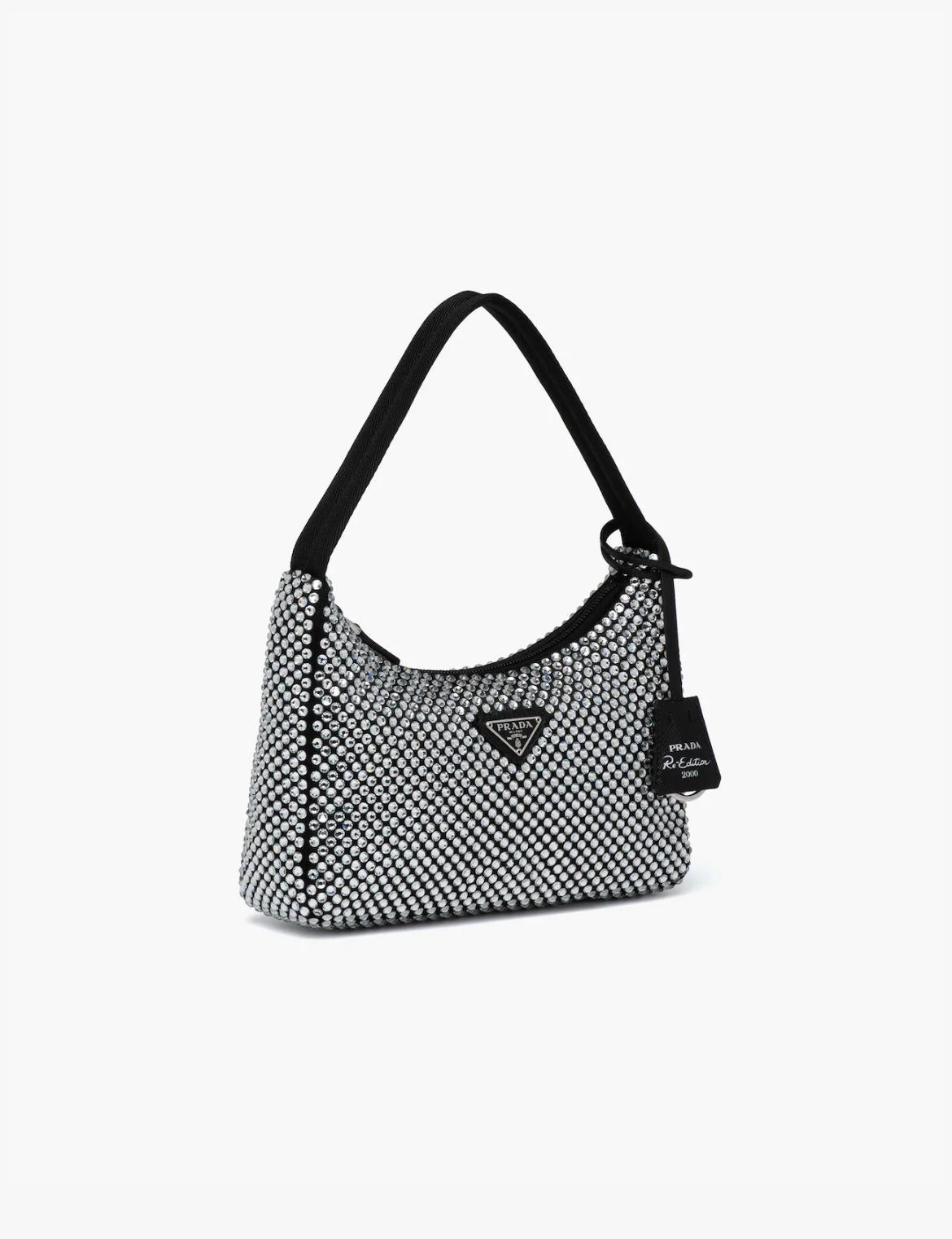 From the collection of SAVINETI we offer this limited edition Prada Crystal Bag:
-	Brand: Prada
-	Model: Crystal Satin
-	Year: 2021
-	Condition: NEW (unused)
-	Extras: Full-Set (including box, dustbag & invoice)

This mini hobo bag, an iconic Prada