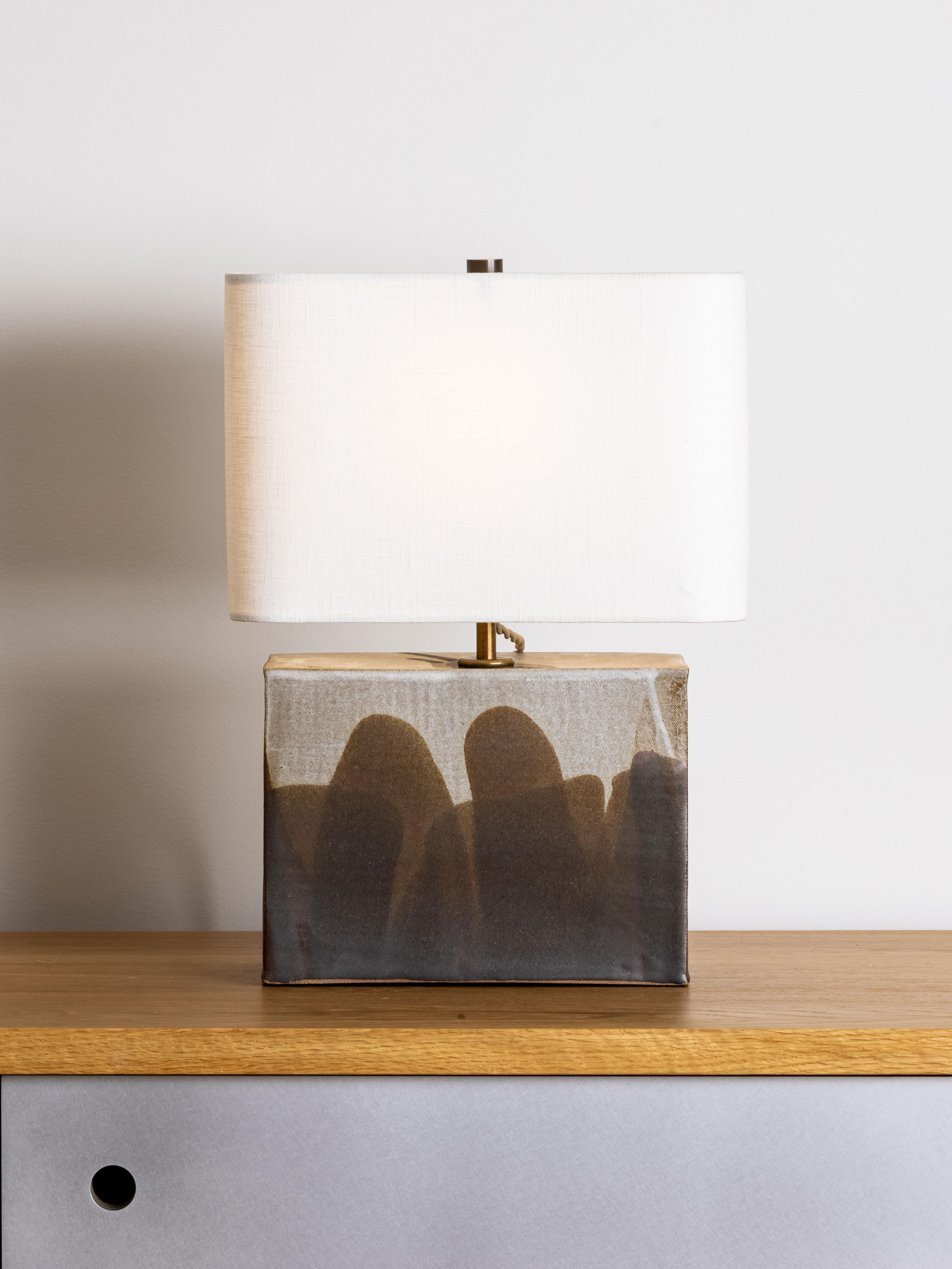Our stoneware New Preston Lamp is handcrafted using slab-construction techniques.

Finish

- Dipped glaze, pictured in parchment & walnut 
- Antique brass fittings
- Twisted black-cloth cord
- Full-range dimmer socket
- Rectangular