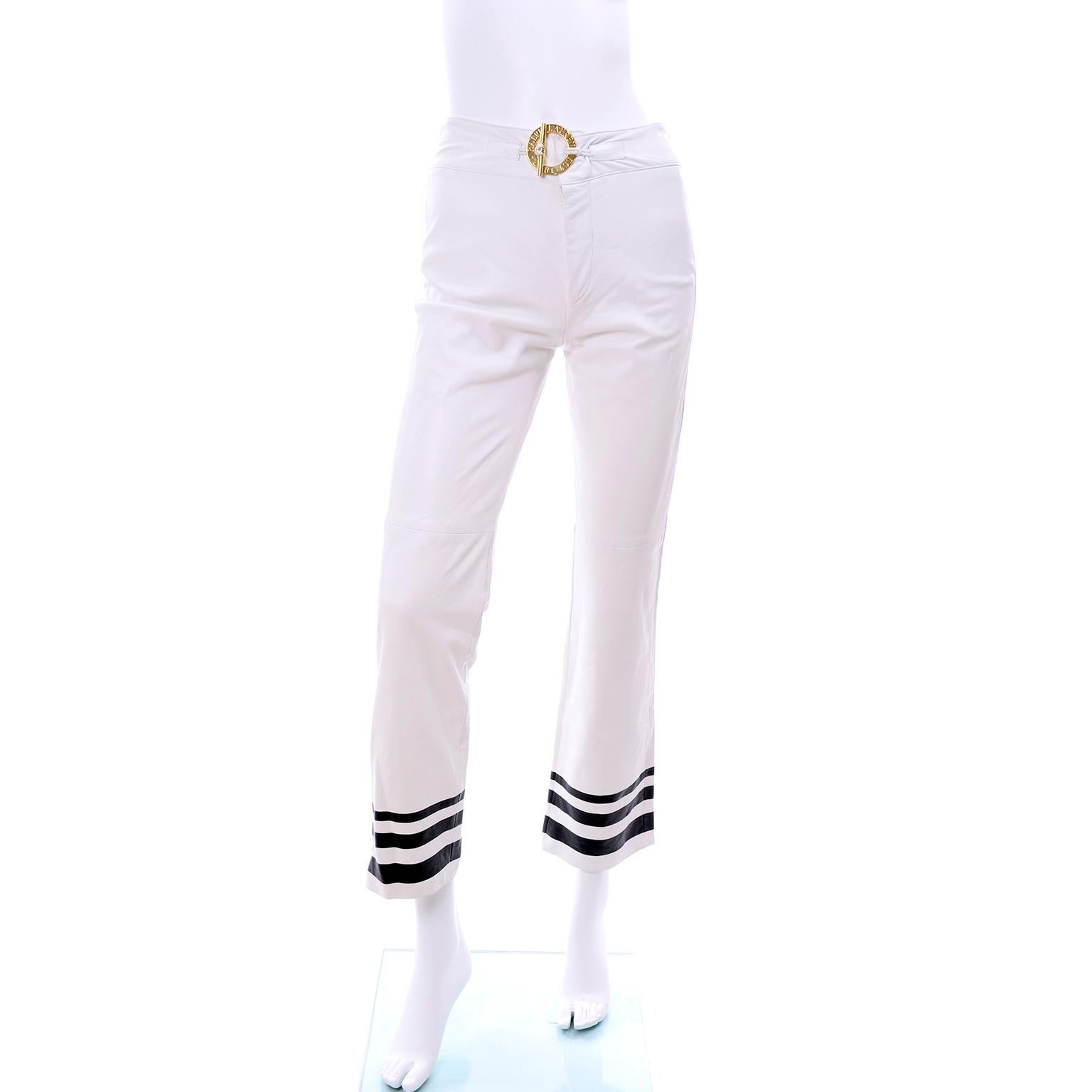 These are new Ralph Lauren white leather pants with the original $1595 price tag attached. These slightly cropped Ralph Lauren fully lined white summer leather pants have nautical inspired navy blue stripes at the hem and a great gold toggle buckle