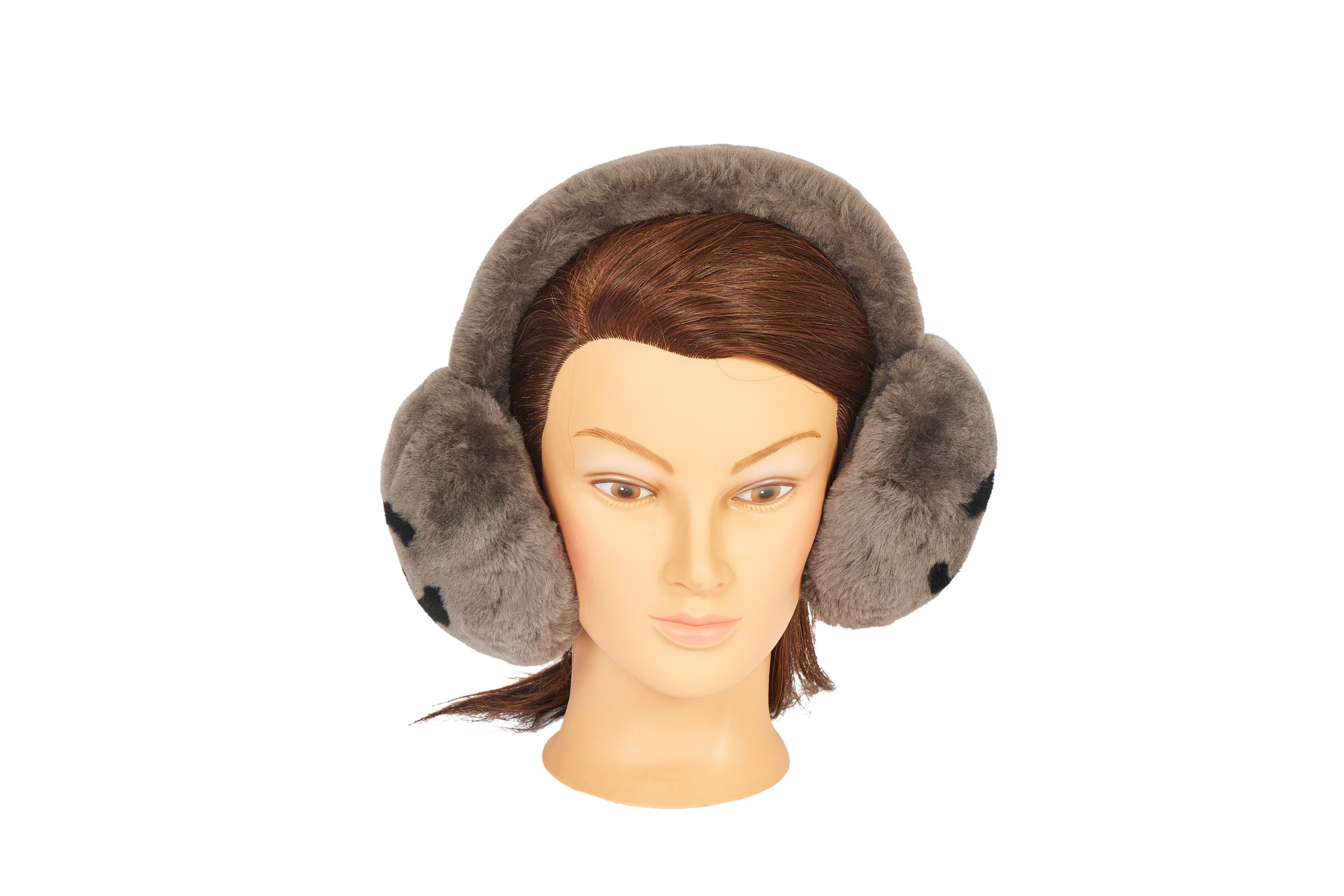 These super rare Chanel ear muffs will keep your ears warm when you're on the slopes. They're made of shearling and colored in grey. But sides show a big double black CC logo. The pieces come in the original Chanel box.