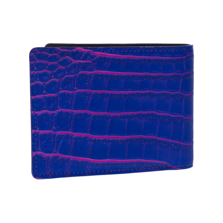 The multiple wallet is made from the rare crocodile  (Crocodylus Niloticus) leather in neon blue with pink veining, a colorway reminiscent of the electronic lights and lasers of the techno music scene
The simple design and small size make this