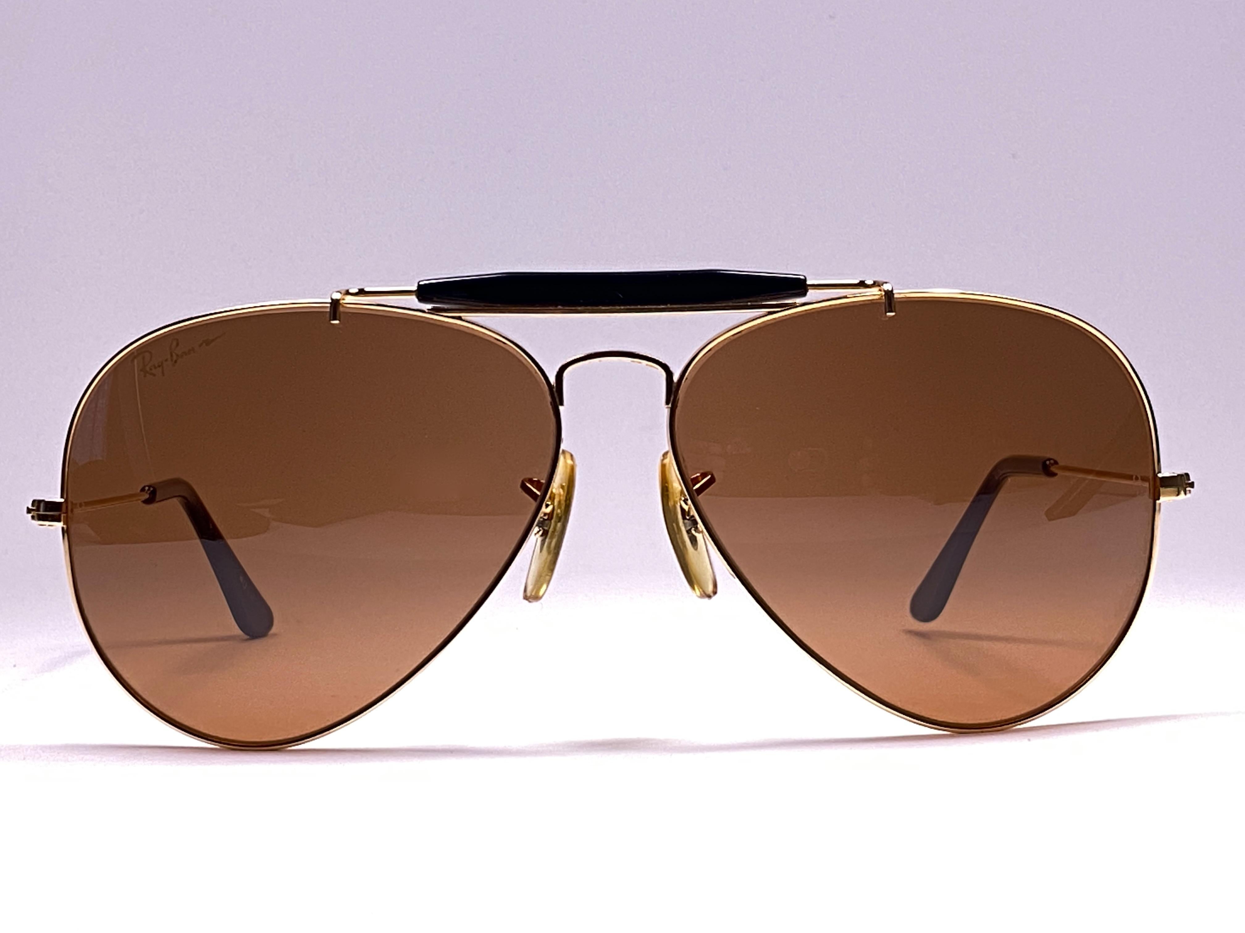 New, rare and sought after Vintage Ray Ban Chromax. 
62MM Outdoorsman gold frame holding a pair of purple Chromax B&L etched lenses.

New, never worn or displayed, this item is a superb find.
It may have minor sign of wear due to storage. 
Comes