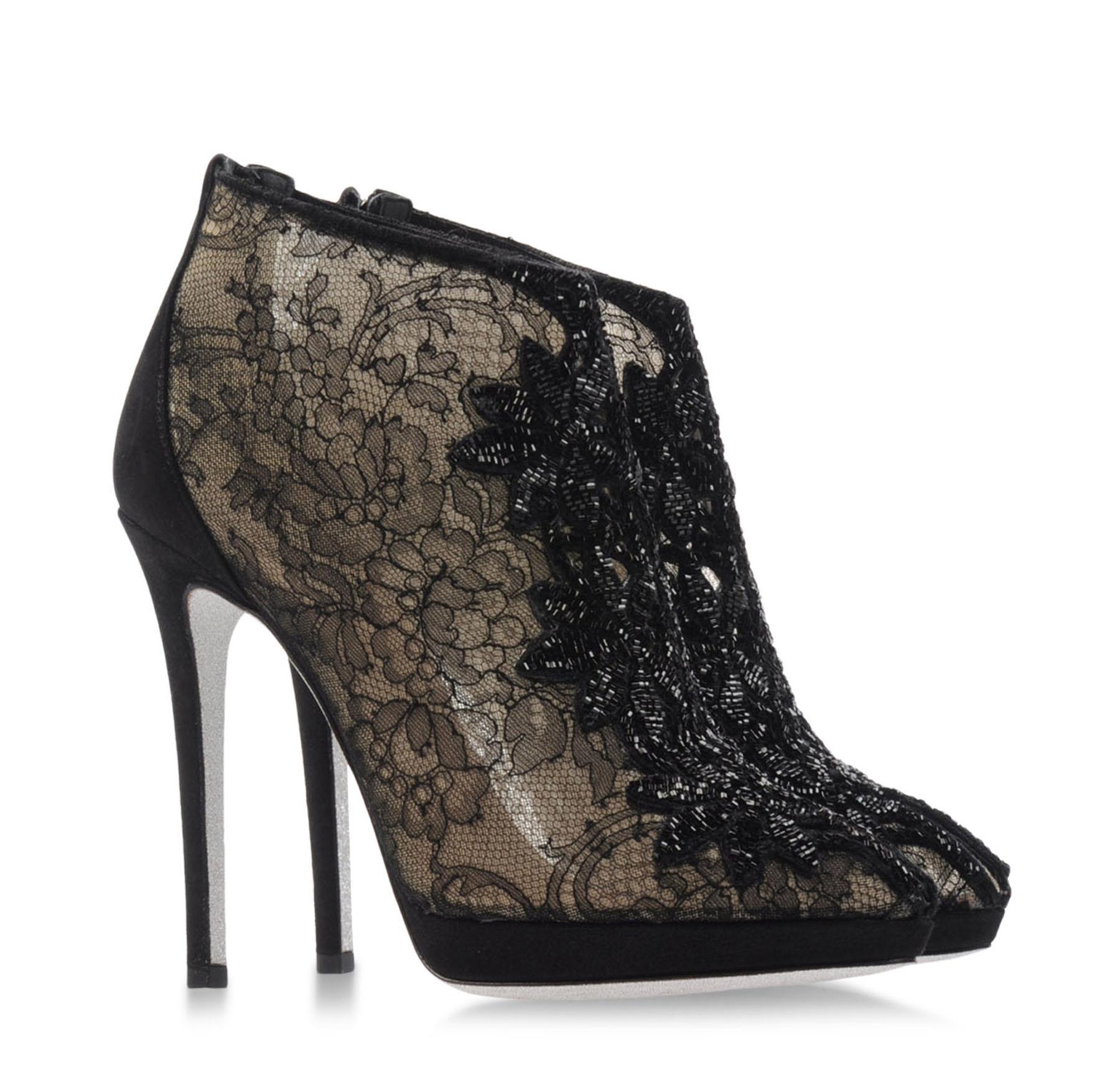 New Rene Caovilla Black Lace Beaded Ankle Booties
Designer size 40 - US 10
This sexy ankle boot is a great addition to your fall cocktail or evening wardrobe. Black floral lace, beads detailed, cutout narrow toe line, glitter signature sole, back