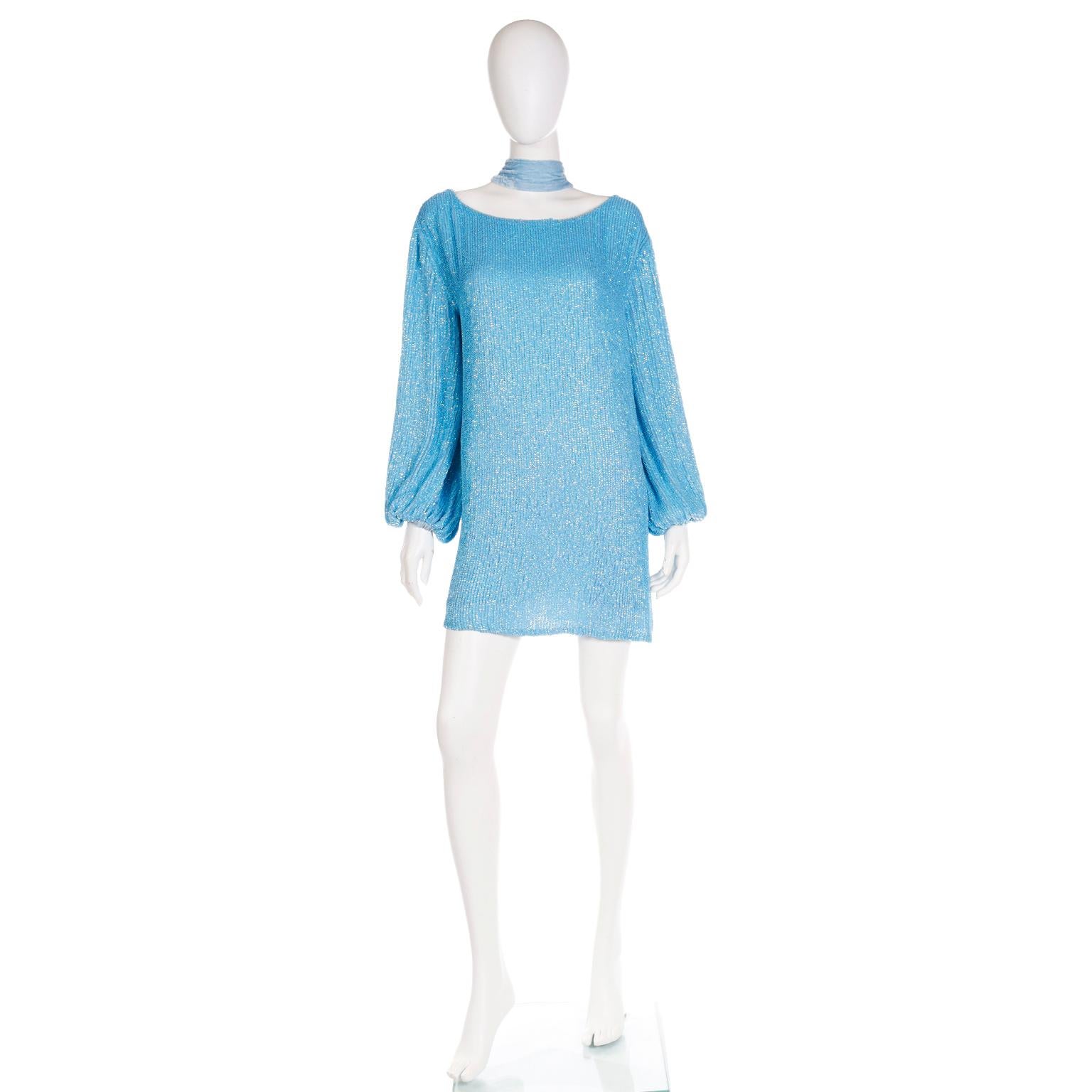 This is a lovely deadstock Retrofete sequin mini dress in a beautiful shade of blue with its original tag still attached.  This fun dress can be worn loosely, belted, or as a tunic over pants. The blue velvet sash style belt can also be worn as a