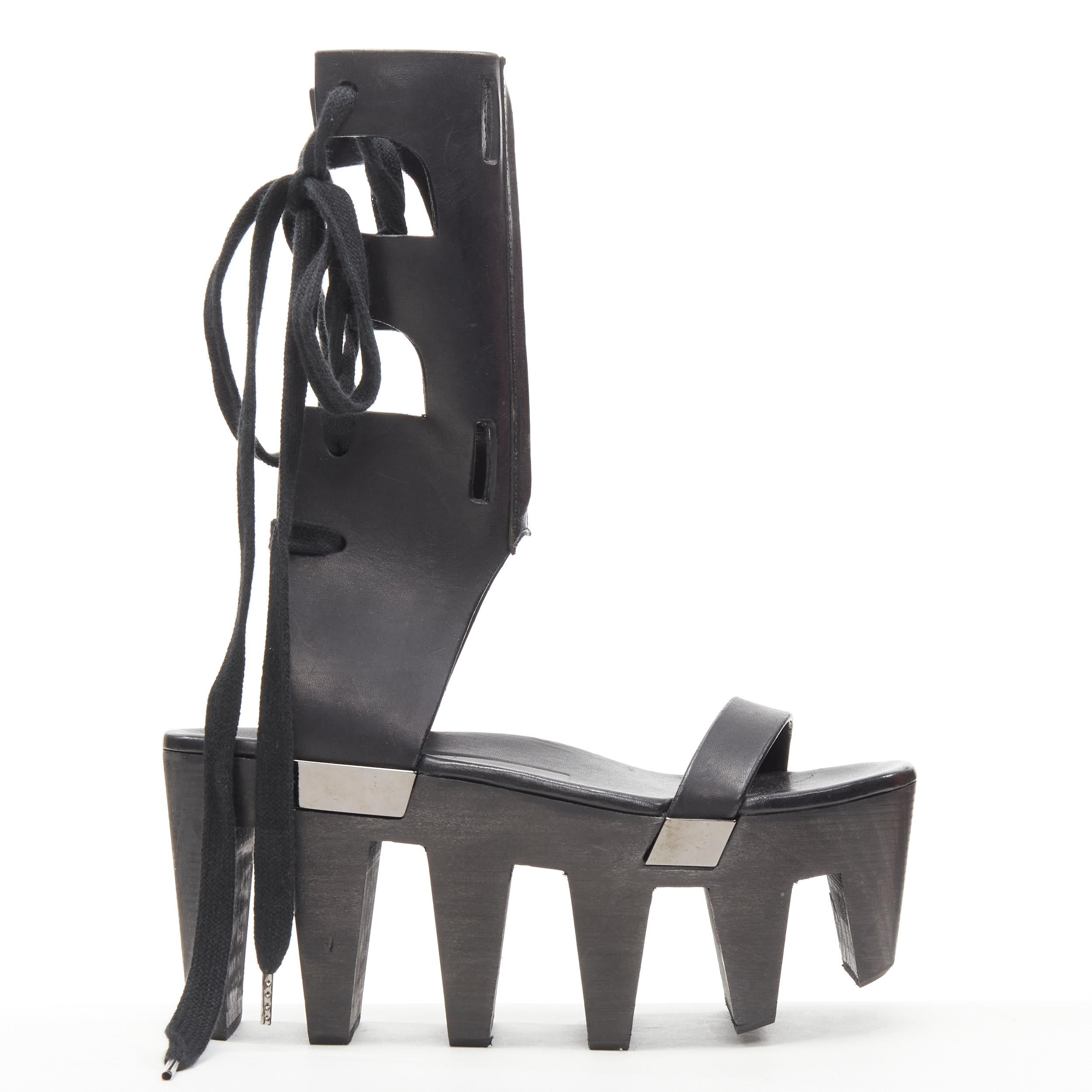 new RICK OWENS 2015 Faun Runway black Geta comb wood sole clog sandals EU37 US7 
Reference: TGAS/C00627 
Brand: Rick Owens 
Designer: Rick Owens 
Model: Geta Clog 
Collection: Spring Summer 2015 Faun Runway 
Material: Leather 
Color: Black 
Pattern: