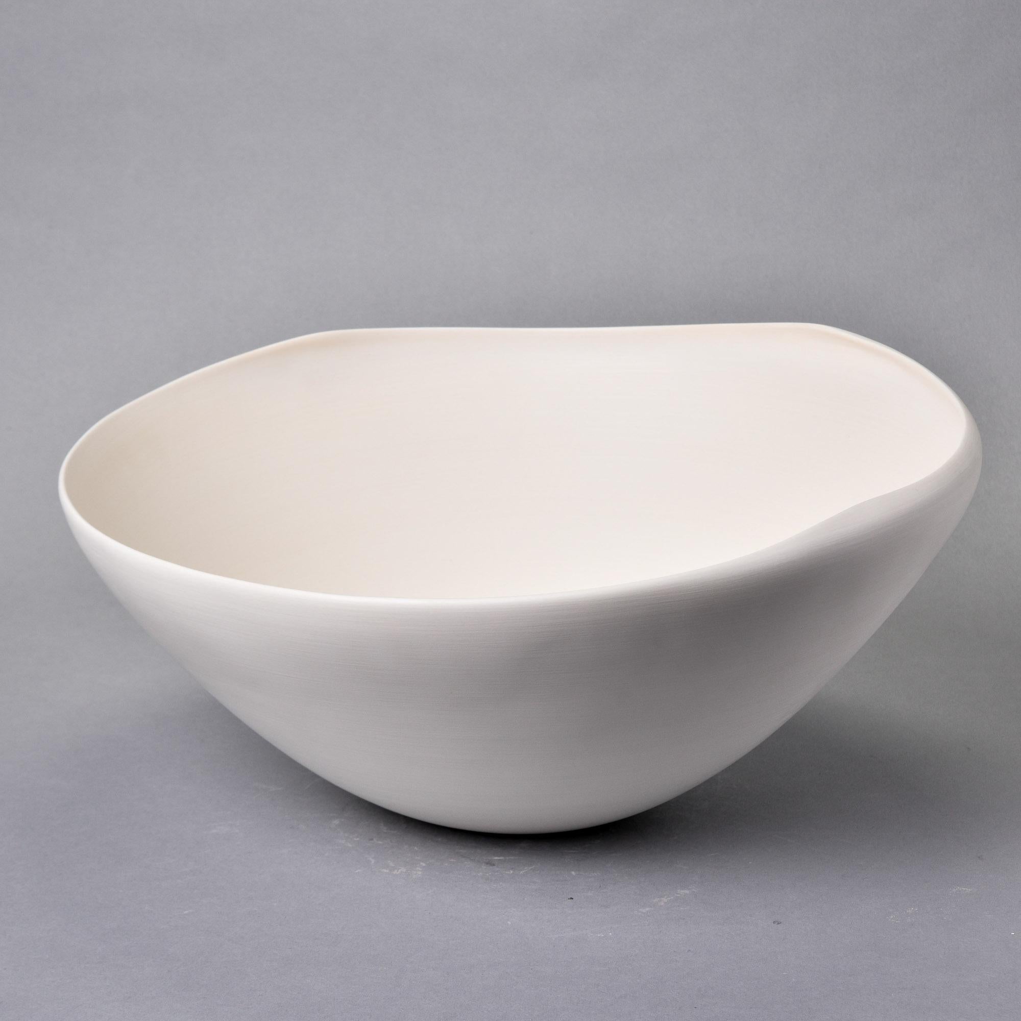 Nouveau et importé d'Italie, ce bol en poterie d'art de Rina Menardi est un bol central ou console à parois minces avec un bord irrégulier et une glaçure blanche osseuse mate. Le dessous de la base porte la marque du fabricant. Nouveau, sans aucun
