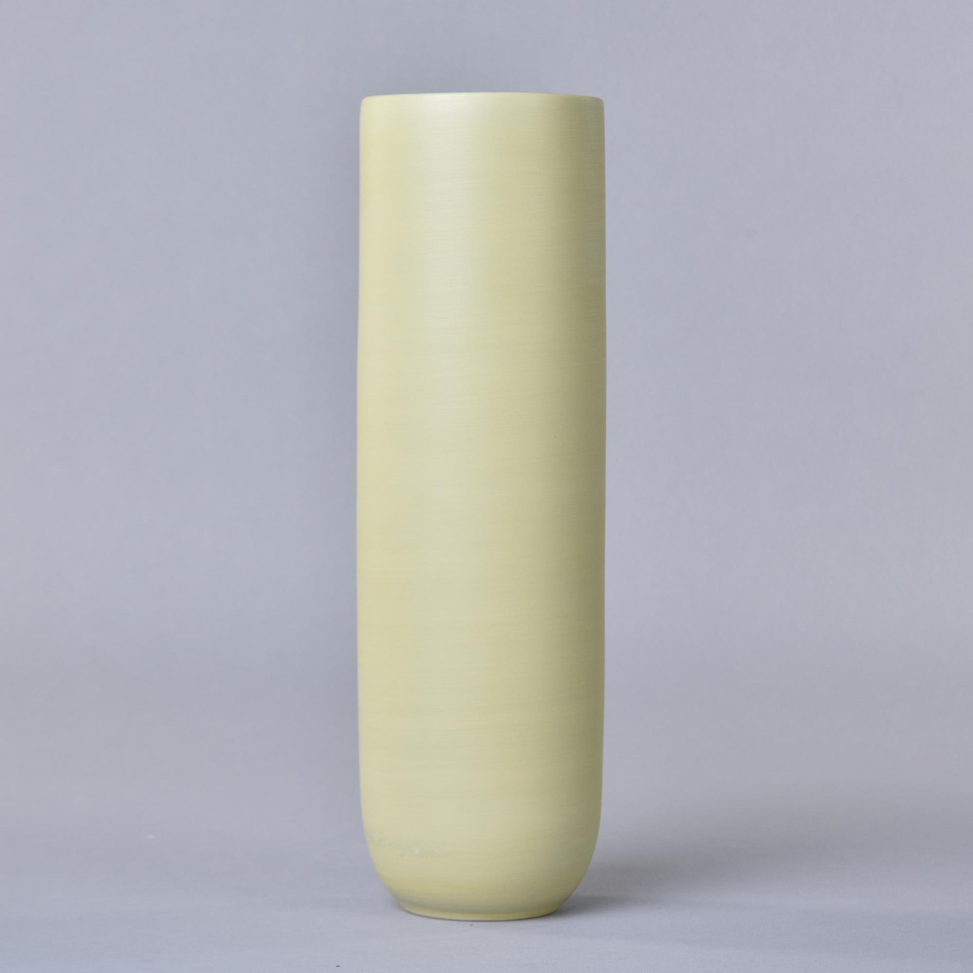 New and made in Italy by Rina Menardi, this ceramic vase is 14” tall. Exterior is glazed in pistachio - a matte finish pale green with a matte black interior. Signed by maker on underside of base. At the time of this posting, we have several other