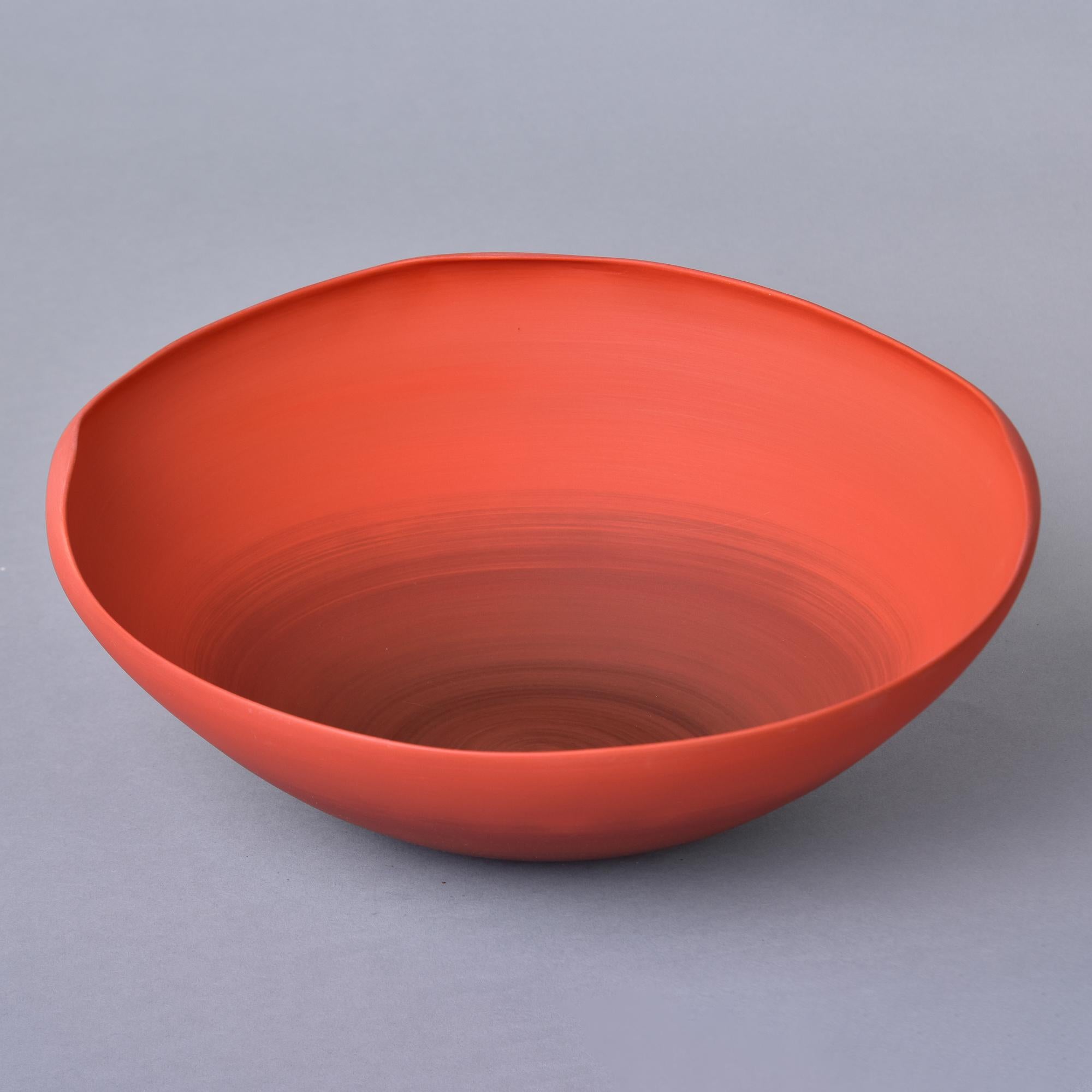 New and imported from Italy, this art pottery bowl by Rina Menardi is a thin-walled bowl with an irregular rim and subtle ombre-style poppy red glaze. Underside of base has maker’s mark. New with no flaws found. Other styles, colors and sizes by