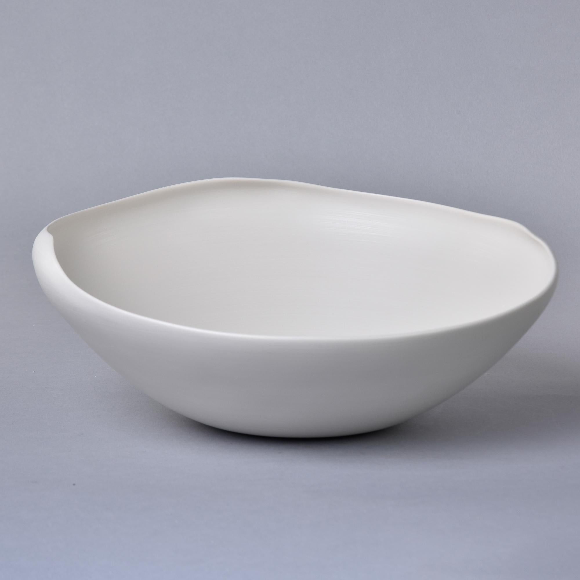 New and imported from Italy, this art pottery bowl by Rina Menardi is a thin-walled bowl with an irregular rim and neutral bone white glaze. Underside of base has maker’s mark. New with no flaws found. Other styles, colors and sizes by this maker