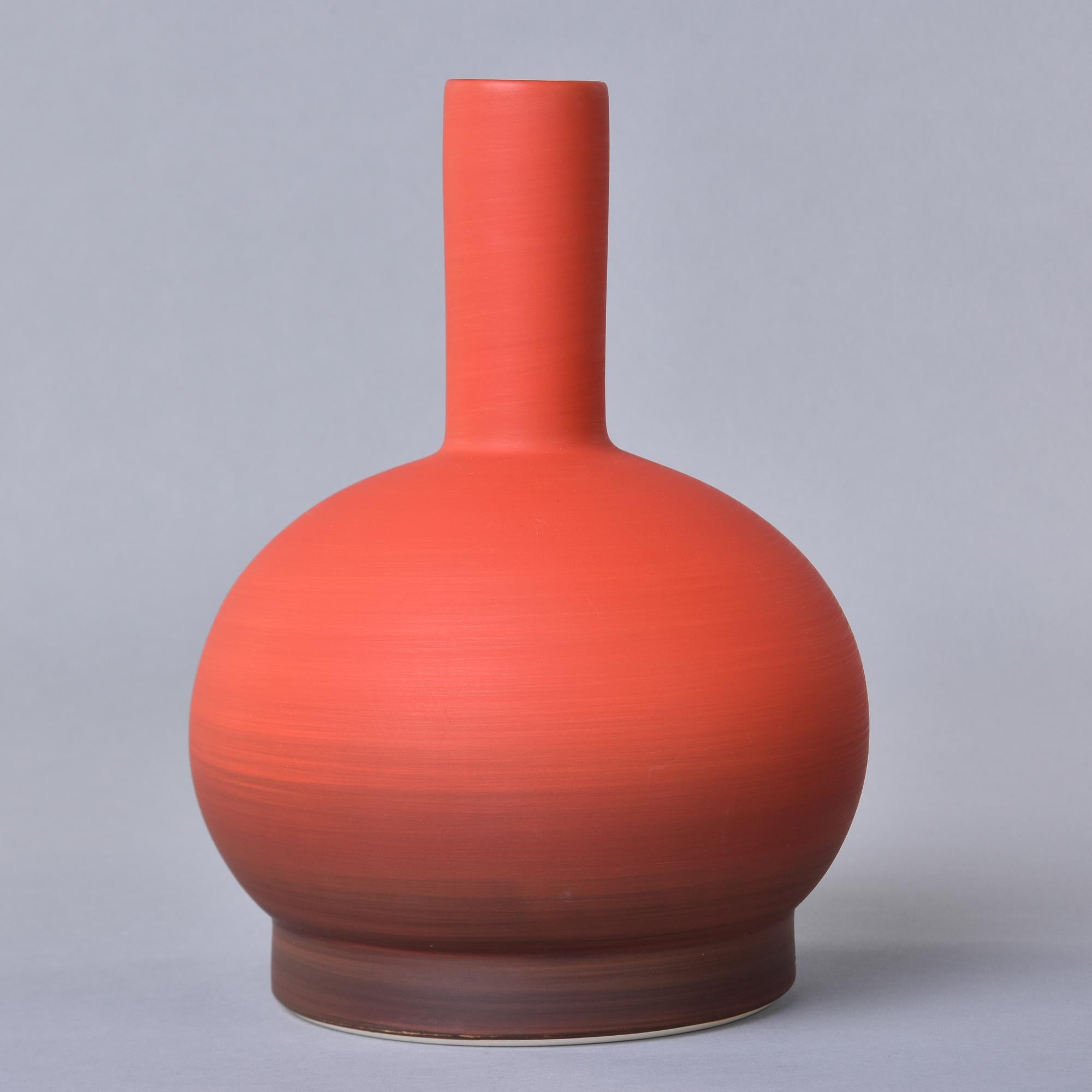 New and imported from Italy, this art pottery vase by Rina Menardi is a thin-walled vessel with generous proportions. Round, globe-shaped base with a tall, narrow neck and vibrant shaded red glaze. Underside of base has maker’s mark. New with no
