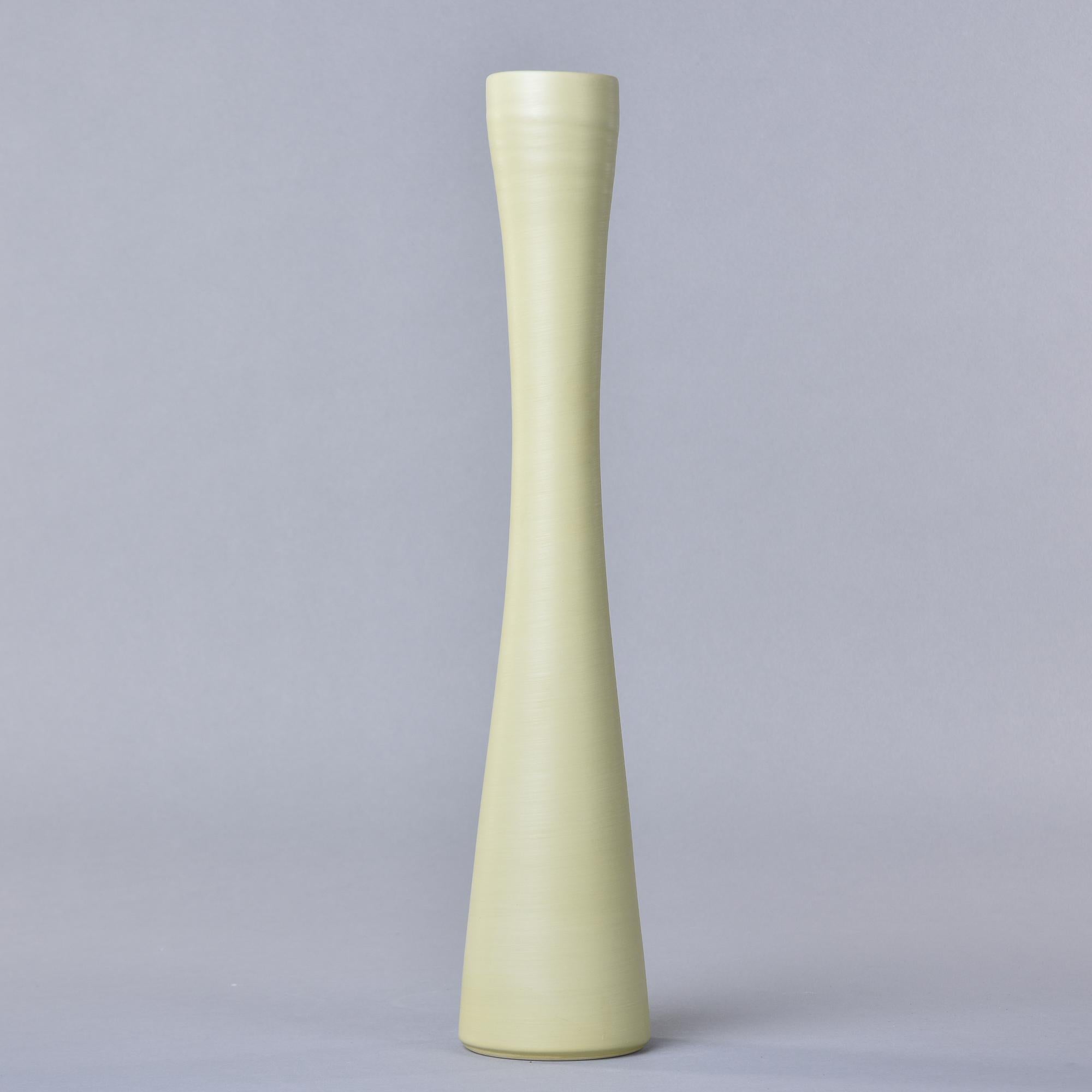 New and made in Italy by Rina Menardi, this tall slender vase is 18” high and has a pale pistachio green colored glaze. Rina Menardi calls this shade of green Pistachio. The inside of the vase has a contrasting soft black wash glaze. Other colors