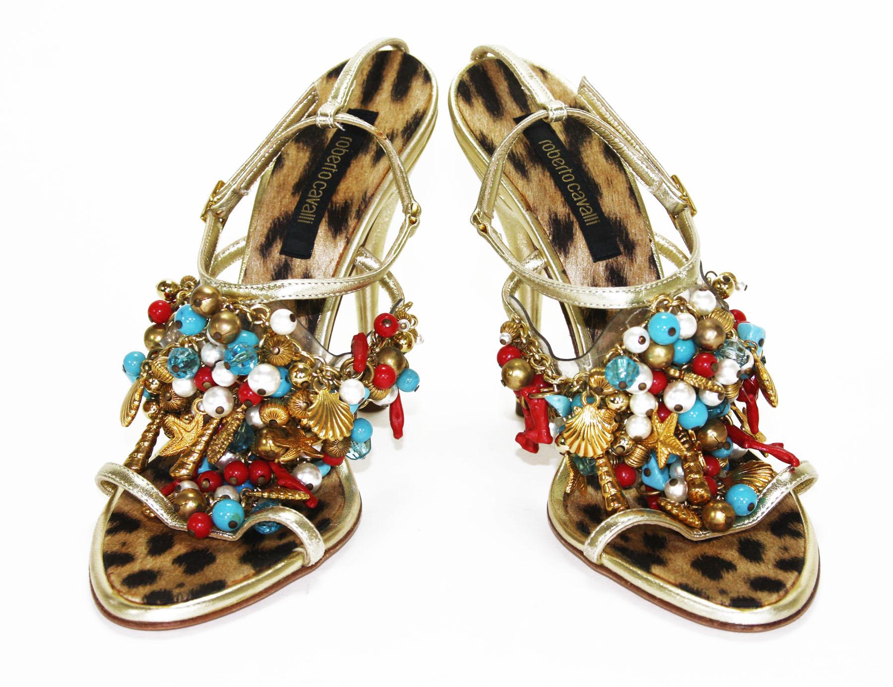 New Roberto Cavalli Embellished Gold Leather Shoes Sandals
Italian size 38.5 - US 8.5
Gold seashells, seahorses and stars; Red coral; White pearls; Red, white and turquoise colored beads - all of them comes together at the same time to decorate