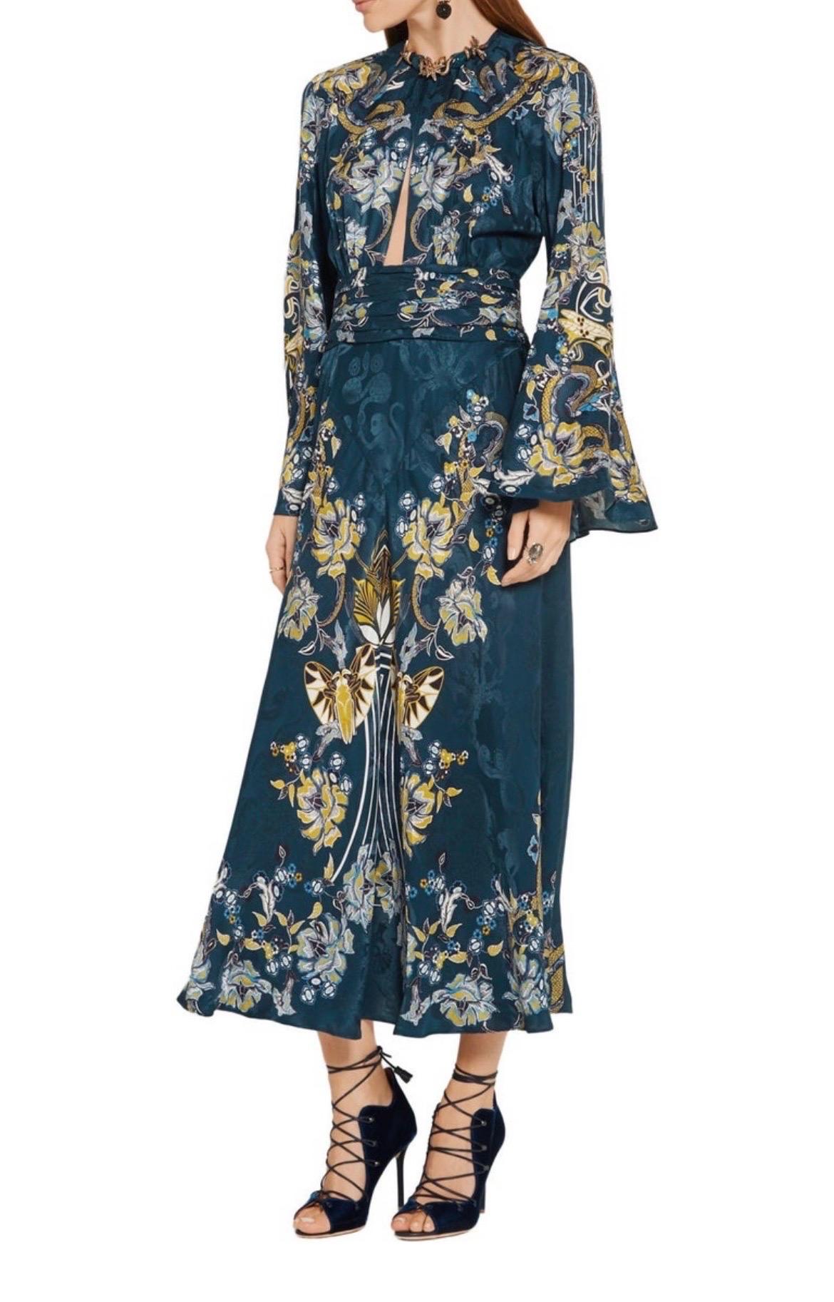 Roberto Cavalli 
Stunning gown with embellishments around the neck.
52% viscose , 48% silk
Made in Italy
Unlined
Front and back keyhole with button closures
Engraved metal charm detail at neckline
Hidden back zip closure
Bell sleeves with slit