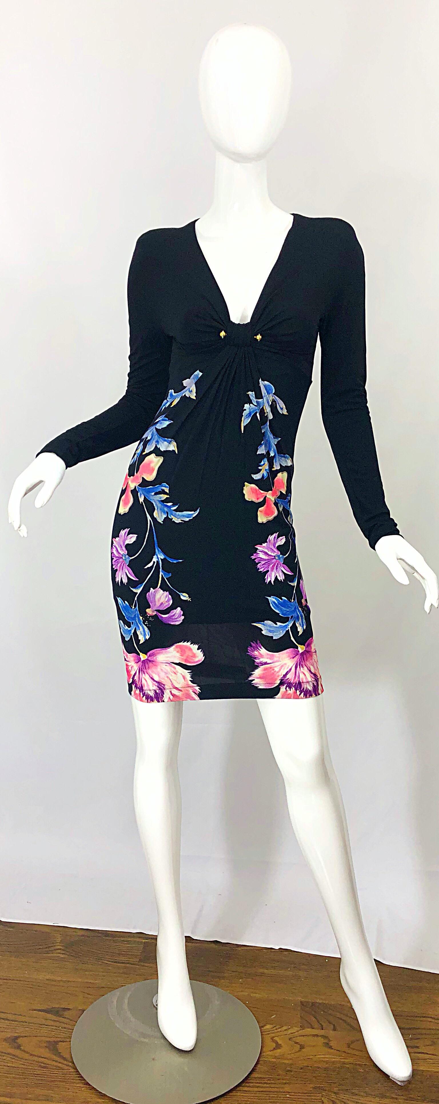 Sexy, yet sophisticated new early 2000s ROBERTO CAVAlLI strong shoulders long sleeve black dress! Features flowers in vibrant colors of pink, blue and purple up each side of the front and back. Rhinestone encrusted detail at the neck. Built in