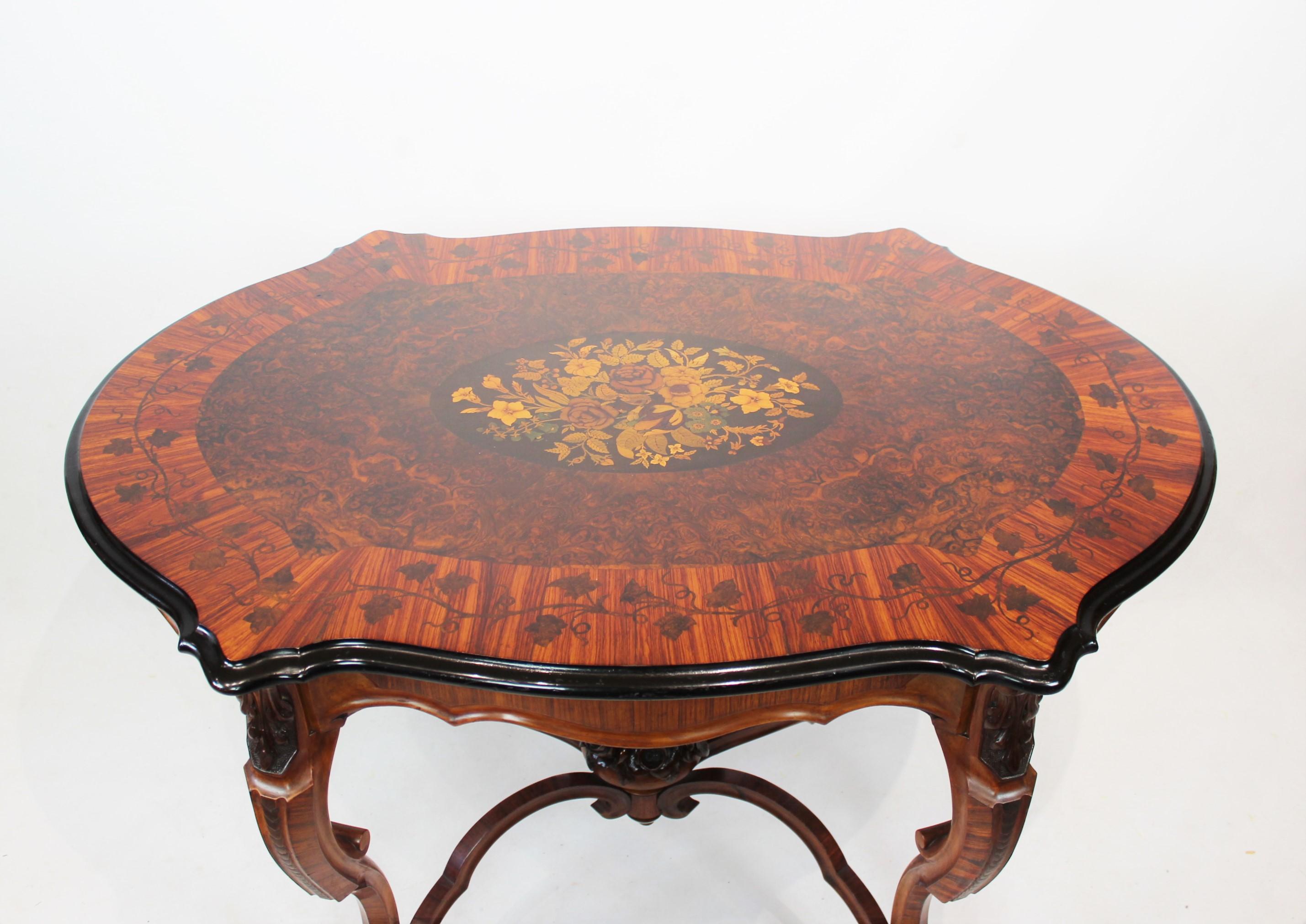 New Rococo pedestal table of walnut with carvings and inlaid intarsia of fruitwood from the 1880s. The table is in great antique condition.
  