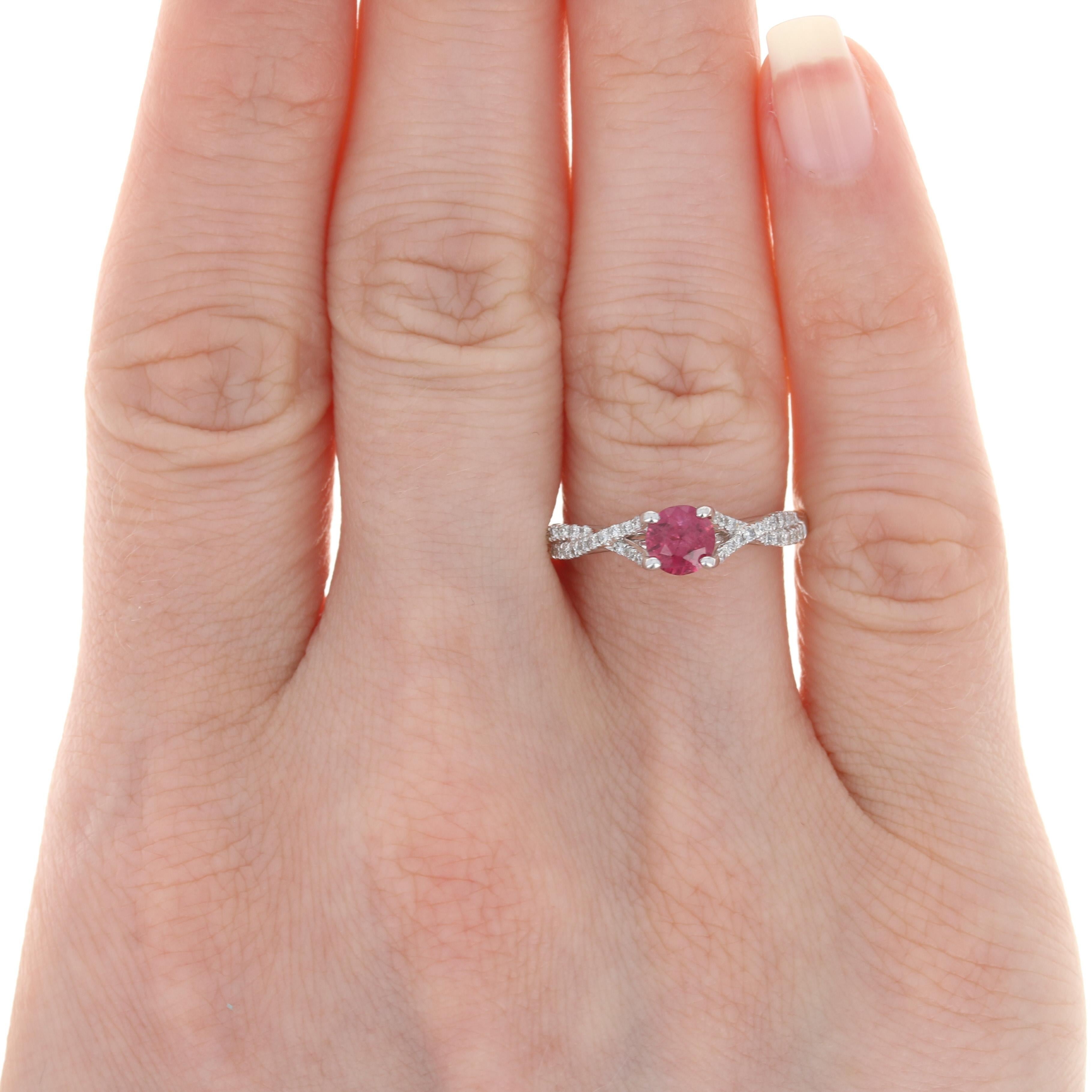 Your quest for the perfect birthday or anniversary gift ends here with this exquisite ring! Fashioned in popular 14K white gold, this NEW ring features a genuine ruby in a half-bezel mounting adorned with peek-a-boo diamond accents. More accent