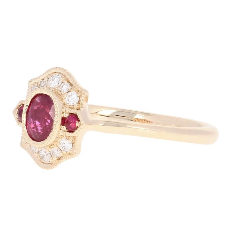 Celebrate the glorious splendor of rubies with this elegant NEW ring! Composed of 14k yellow gold, this romantic piece showcases a luminous ruby solitaire surrounded by two smaller rubies and ten white diamonds which are all outlined by milgrain