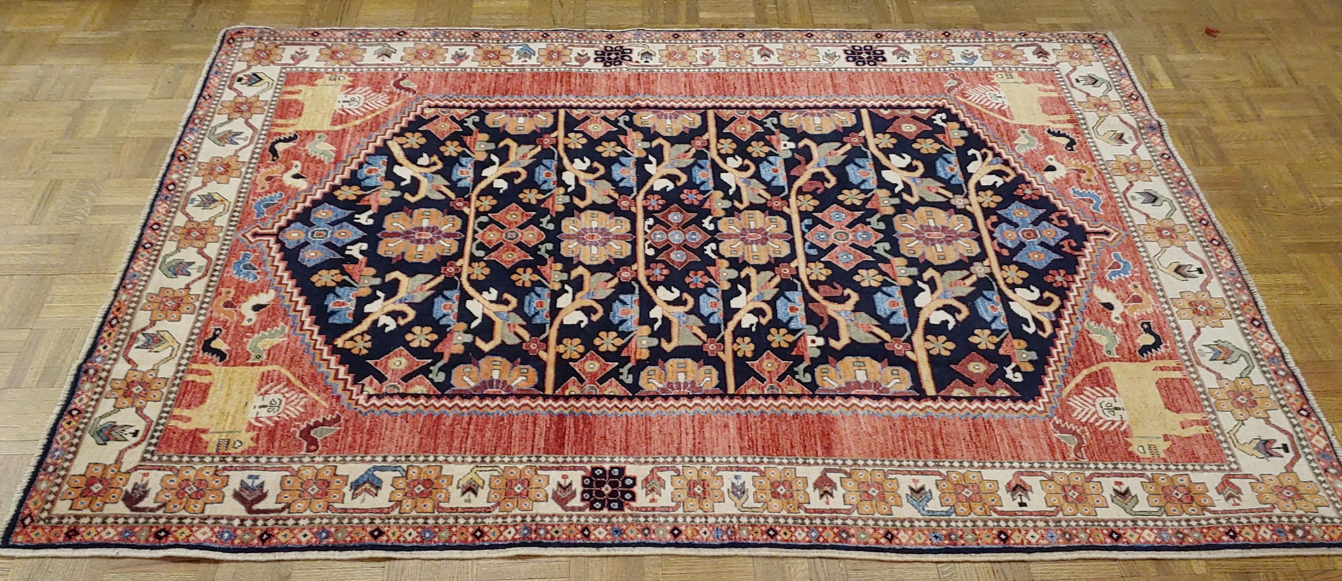 This is one of the best new rugs we offer. Handwoven in Afghanistan, these rugs offer a superior hand-spun Afghanistan wool with a striking medley of wonderful, all natural dyes. The designer borrows motif elements from Classic Antique Persian and