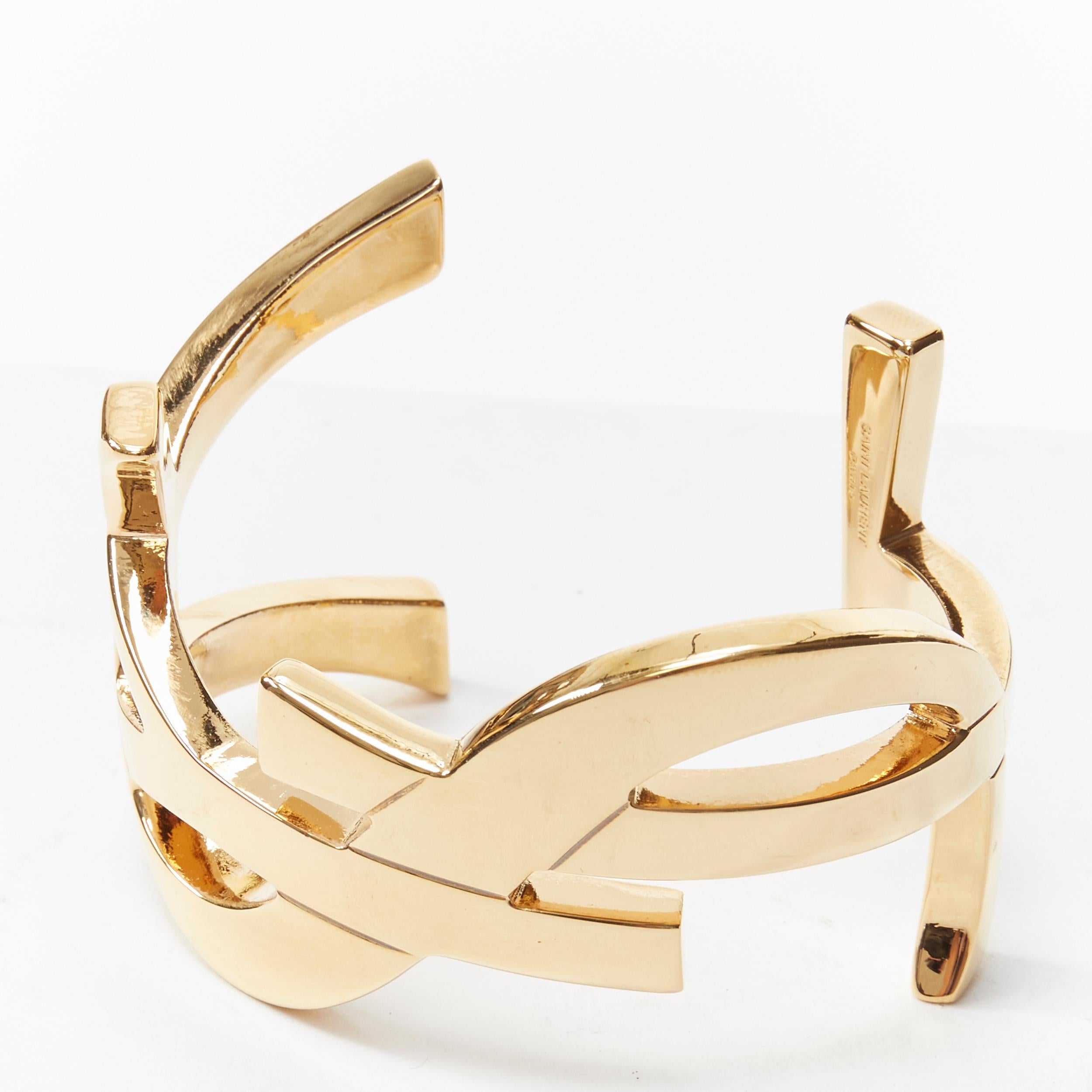 new SAINT LAURENT Cassandre gold brass metal YSL monogram logo cuff bracelet 
Reference: TGAS/B01797 
Brand: Saint Laurent 
Designer: Hedi Slimane 
Color: Gold 
Pattern: Solid 
Extra Detail: Cassandre cuff. YSL logo design. Plated brass metal cuff