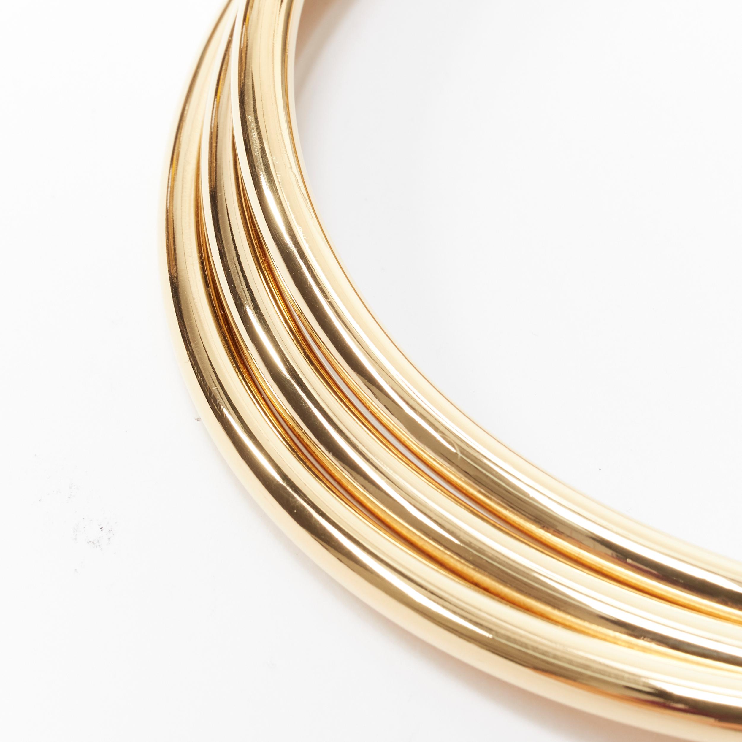 new SAINT LAURENT Hedi Slimane gold triple bar twisted choker necklace 
Reference: TGAS/B01730 
Brand: Saint Laurent 
Designer: Hedi Slimane 
Material: Metal 
Color: Gold 
Pattern: Solid 
Extra Detail: Triple bar twist choker necklace. Signed at