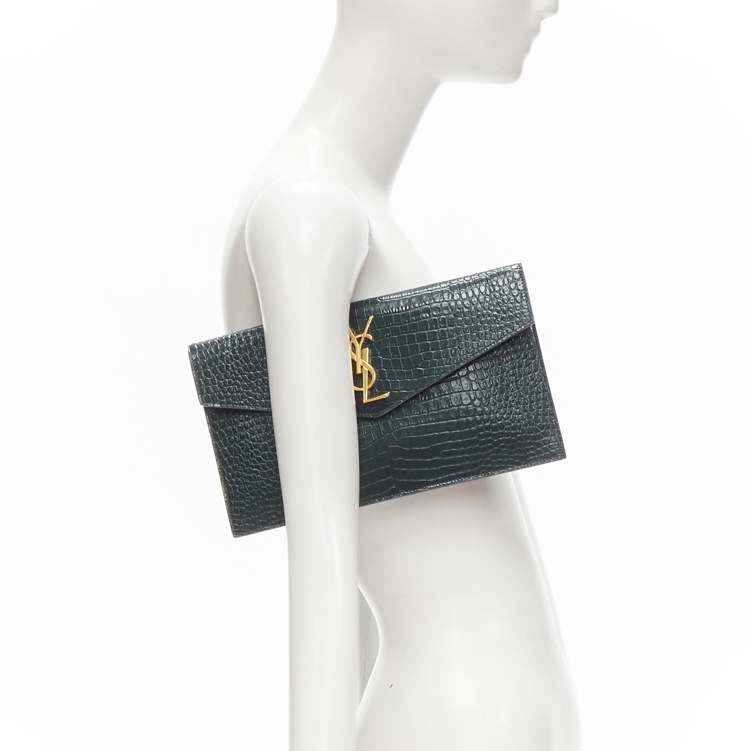 new SAINT LAURENT Uptown green croc embossed gold YSL logo envelope clutch bag 
Reference: AEMA/A00104
Brand: Saint Laurent 
Collection: Uptown 
Material: Leather 
Color: Green 
Pattern: Solid 
Closure: Magnet 


CONDITION:
Condition: New with