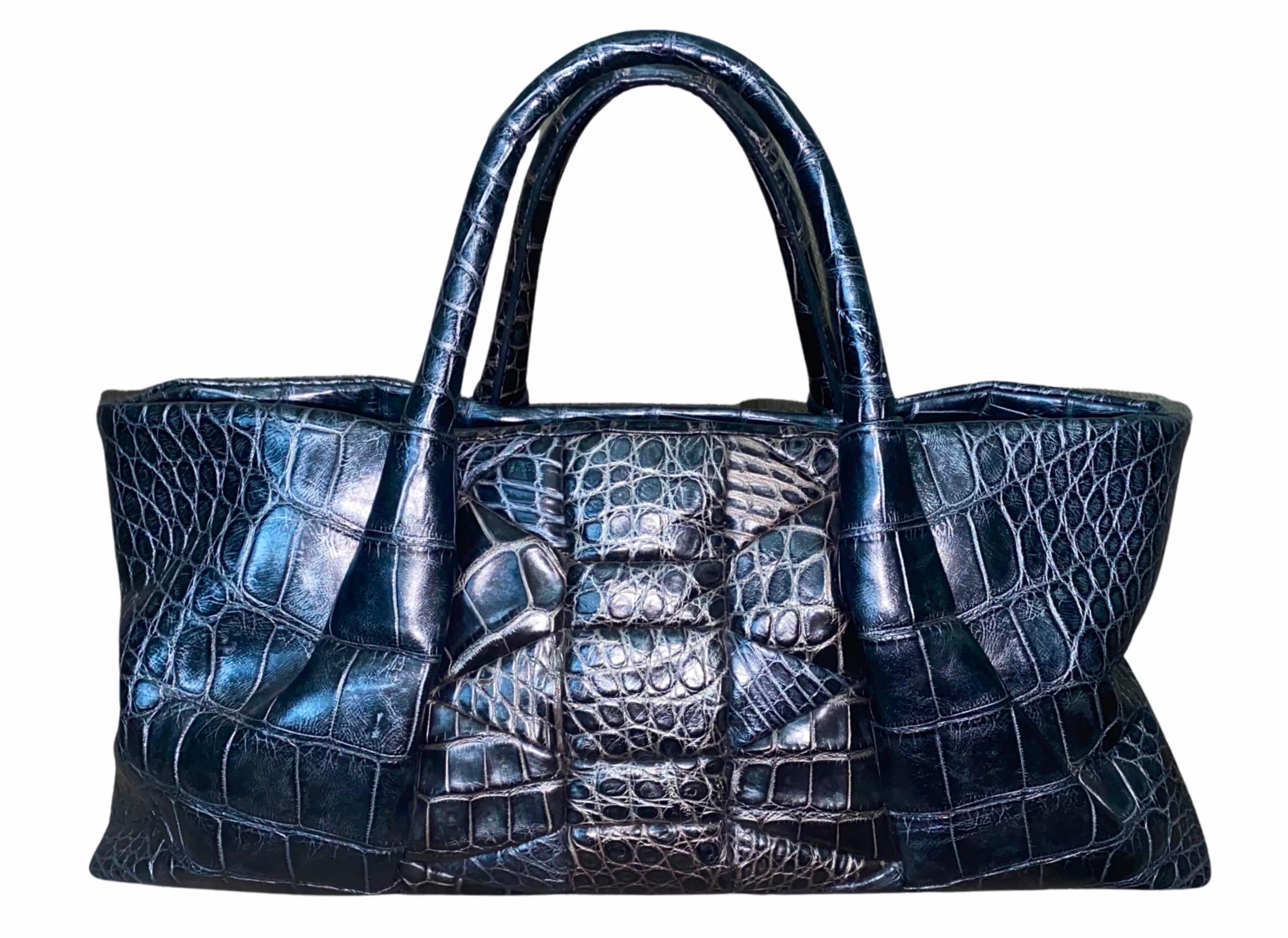 New & Stunning Alligator Skin Shoulder Bag by Salvatore Ferragamo - a timeless classic!

Made of finest alligator skin
Graphite grey color
Fully lined with beige suede leather
One inner bag with zip closure, three open inner bags for phone