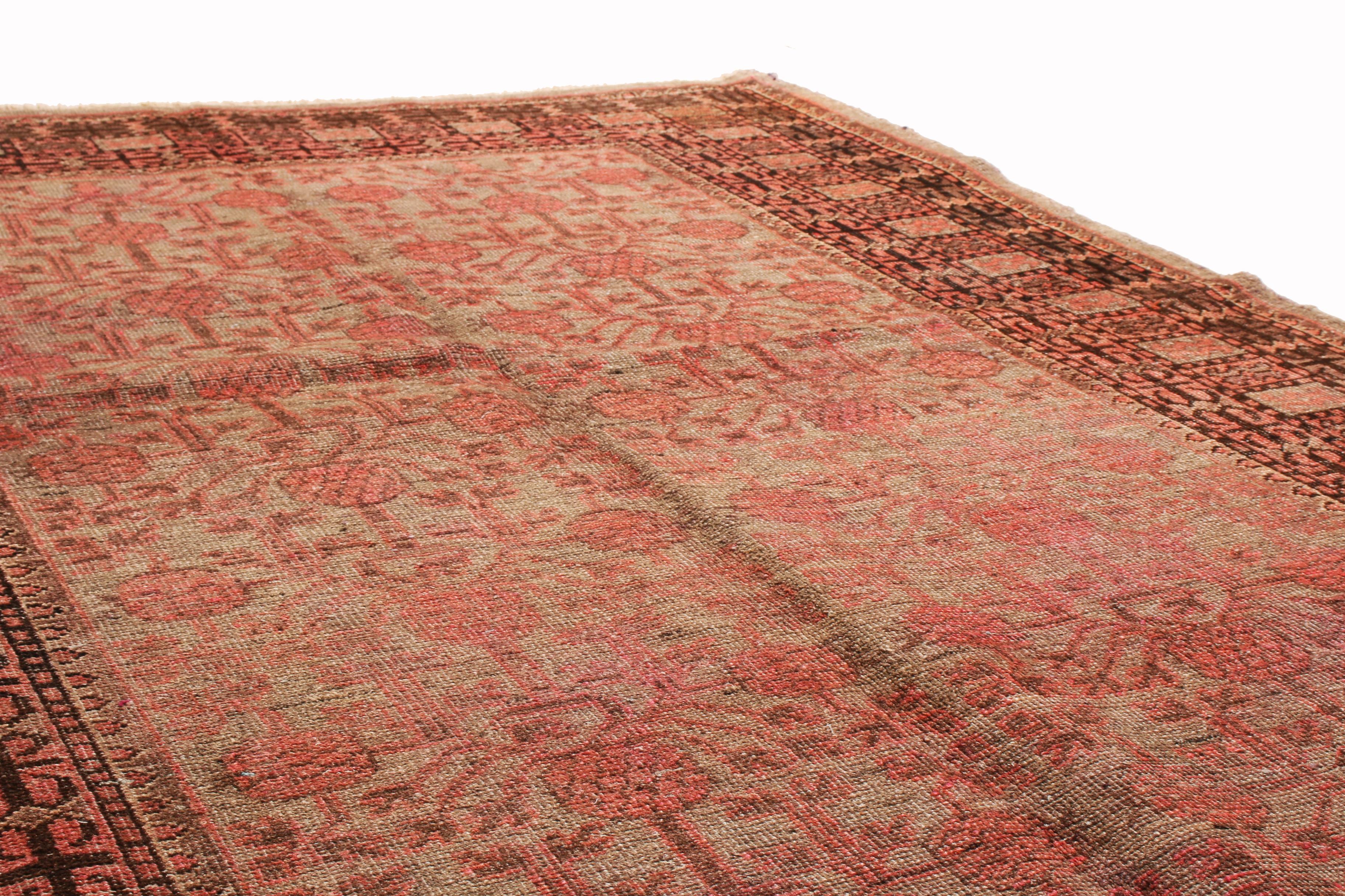 Originating from India, this new traditional Samarkand wool rug employs many features remarkably similar to antique Khotan rugs. Hand knotted in high-quality wool, the all-over field design portrays red and black pomegranates against a blue