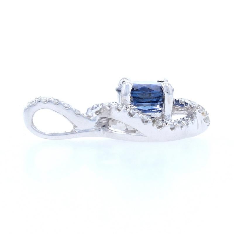 Vivaciously sparkling, this stunning NEW piece will be the perfect gift for your princess! This 14k white gold pendant features a dazzling blue sapphire surrounded by a glittering halo of icy white diamonds which extend up the stationary