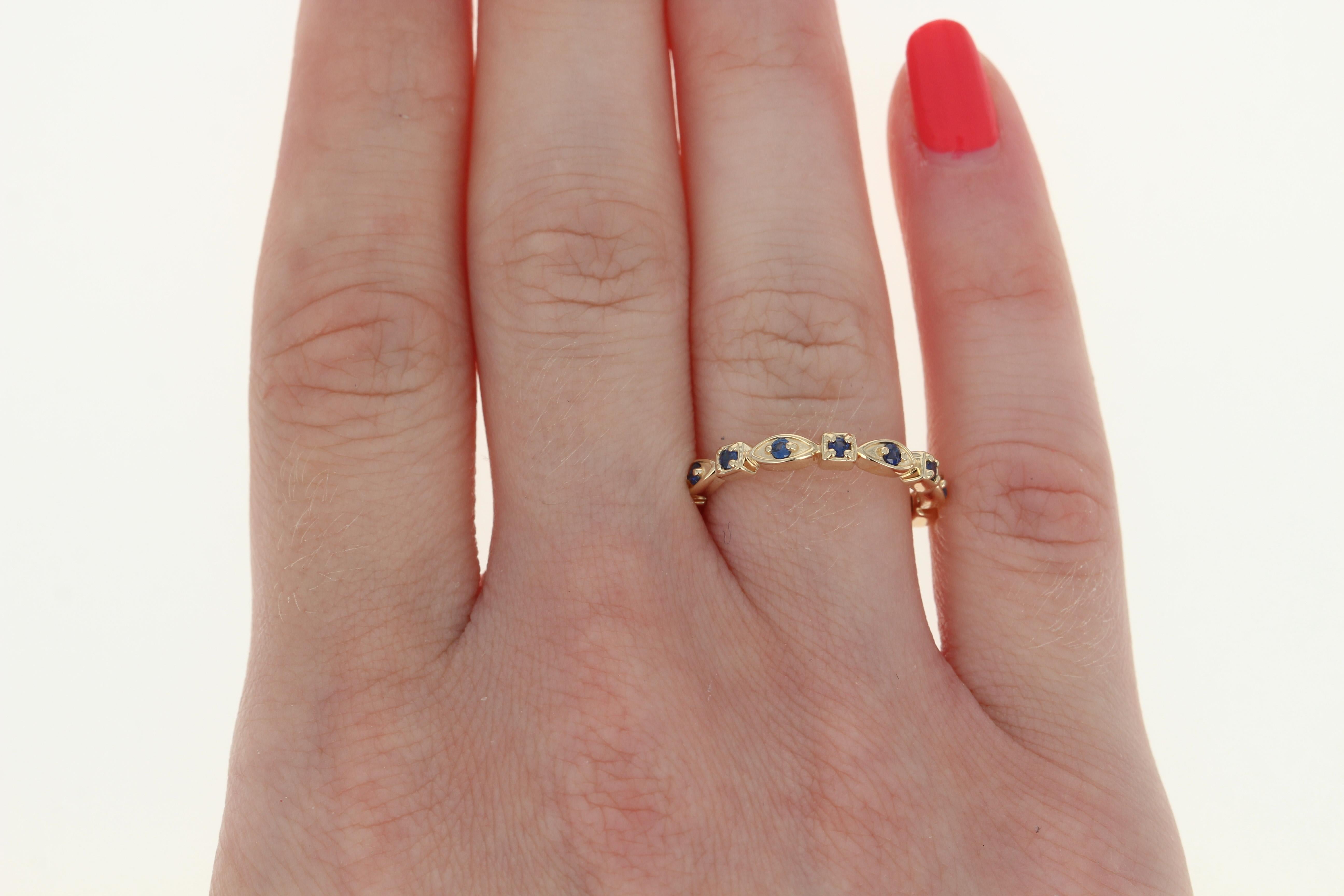 Add a sweet splash of vivacious color to your wardrobe with this gorgeous NEW ring! Crafted in glowing 14k yellow gold, this band is fashioned in a romantic eternity style design adorned with shimmering blue sapphires. 

This ring is a size 7.