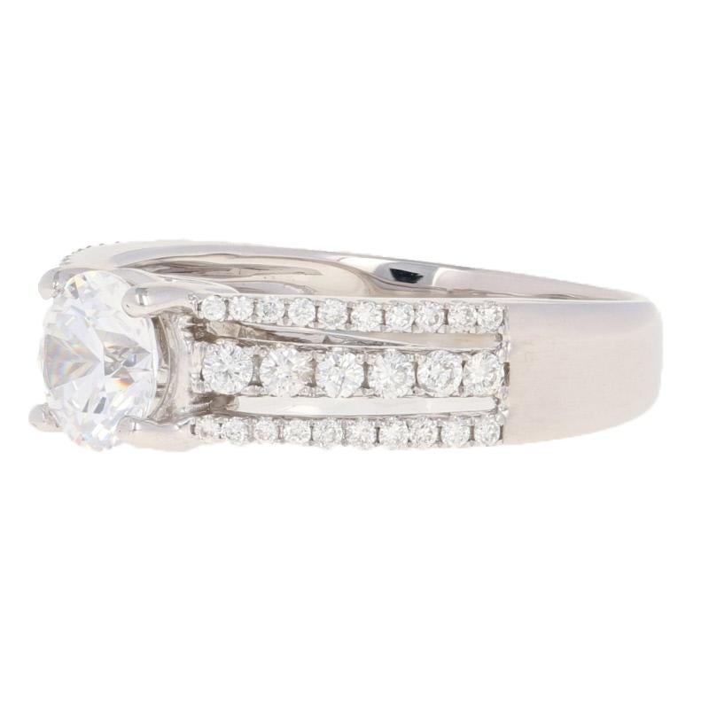 Surprise your sweetheart with an engagement piece personalized just for her! Beautifully highlighted by the three rows of sparkling diamond accents, this NEW semi-mount ring is crafted in luxurious 18k white gold and features a cubic zirconia