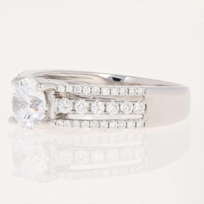 Surprise your sweetheart with an engagement piece personalized just for her! Beautifully highlighted by the three rows of sparkling diamond accents, this NEW semi-mount ring is crafted in luxurious 18k white gold and features a cubic zirconia