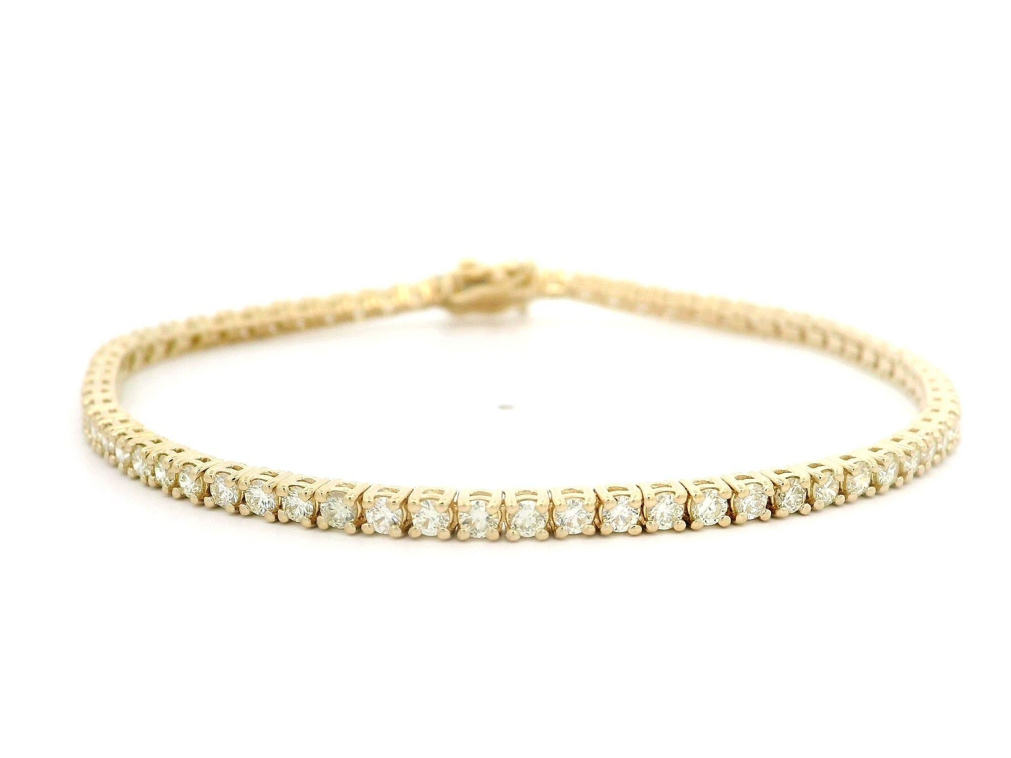 –Stone(s)–
(68) Natural Genuine Diamonds - Round Brilliant Cut - Prong Set - I/J Color - VS1/VS2 Clarity - 2.71ctw (exact)

Material: Solid 14k Yellow Gold
Weight: 7.2 Grams
Type: Tennis Line Link Tennis
Length: Measures 7.0” Next to a Ruler, Will