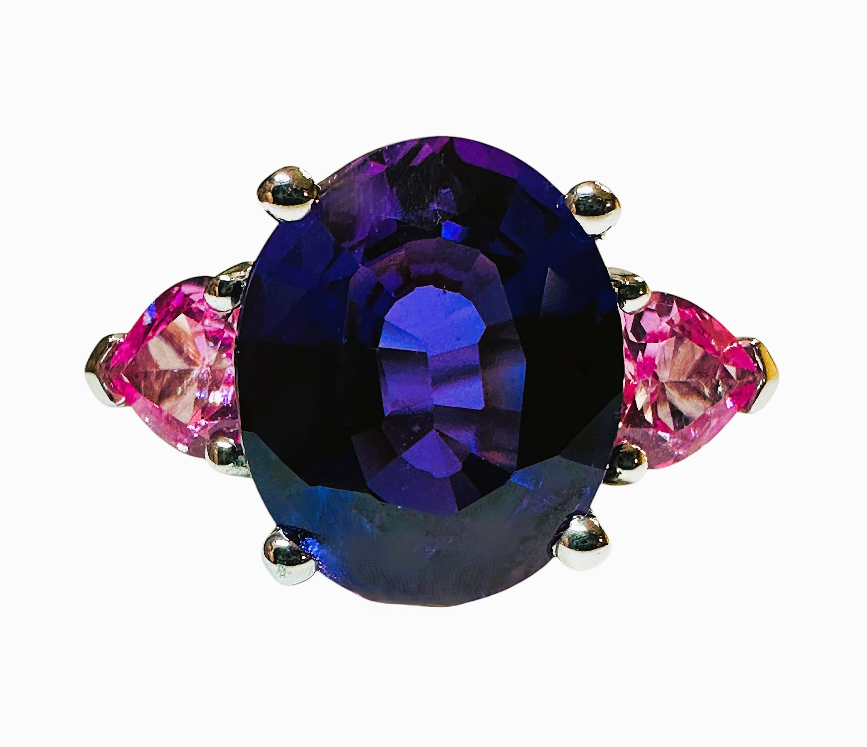 This ring is just gorgeous.  The ring is a size 7.  The Sapphire stone is from Sri Lanka and is 6.12 cts.  The main stone is an oval cut stone and measures 12 x 10 mm.  It is flanked by trillion cut pink sapphires.  The weight in Grams is 4.34.  