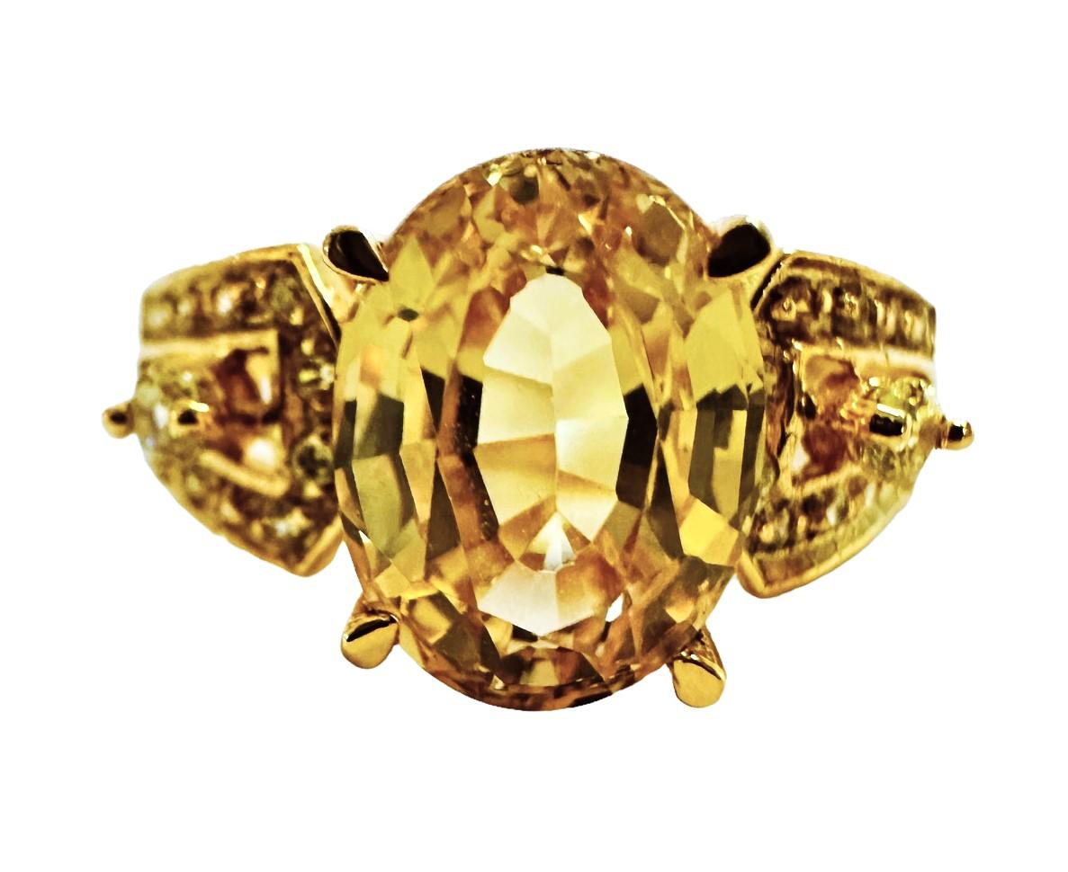 What a beautiful ring!  The ring is a size 6.75.  A very high quality stone.  It is an oval cut stone and is 2.90 Cts.   The main stone is 9 x 7 mm.  It is surrounded by Diamond Cut Yellow Sapphires.  A very classy design.  The ring is sizable and