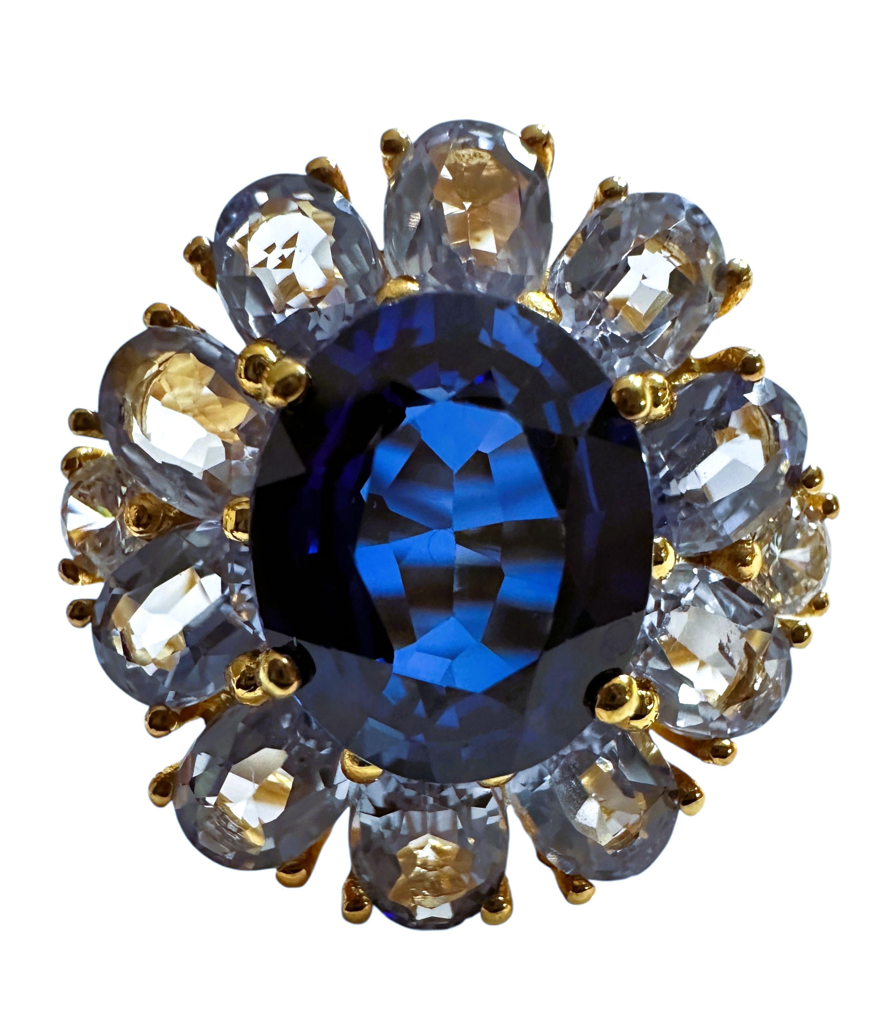 This ring is just gorgeous.  he ring is a size 6.5.  The Sapphire stones are from Sri Lanka and are just exquisite.  The main stone is an oval cut stone and measures 10.8 x 8.8 mm and it is surrounded by  10 oval pedal stones in light blue sapphire