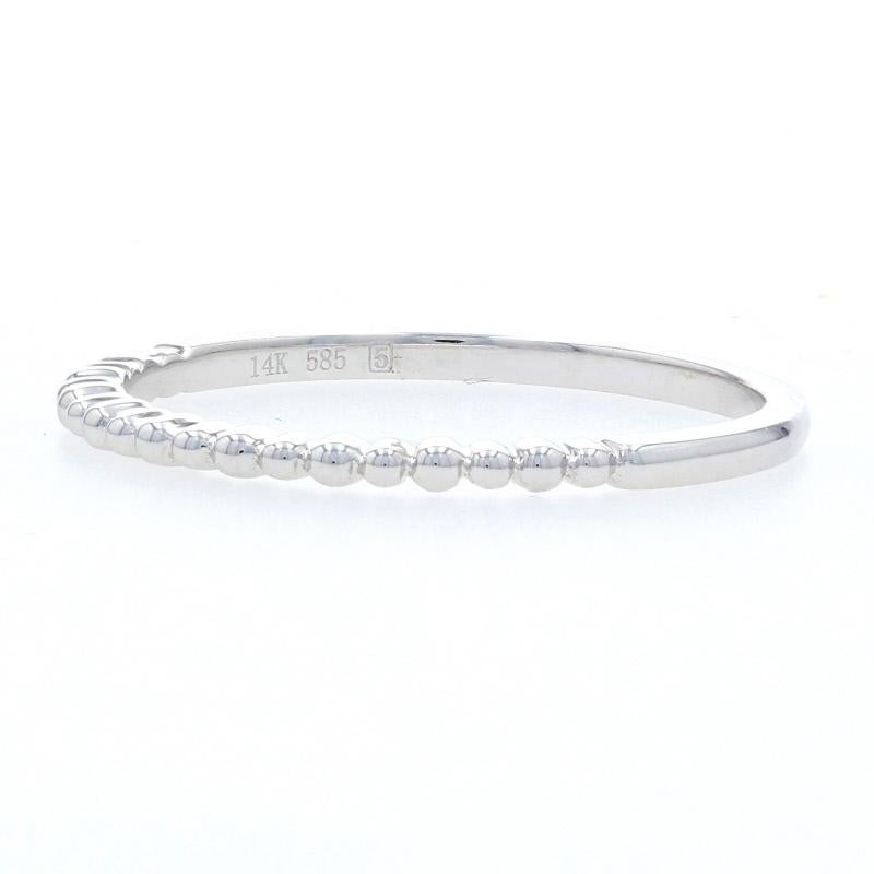 Give your ring collection a new look when you add this band! Fashioned in popular and versatile 14k white gold, this NEW ring can be worn as a solo accessory or stacked with other pieces for an up-to-the-minute look. The face of the band is beaded,