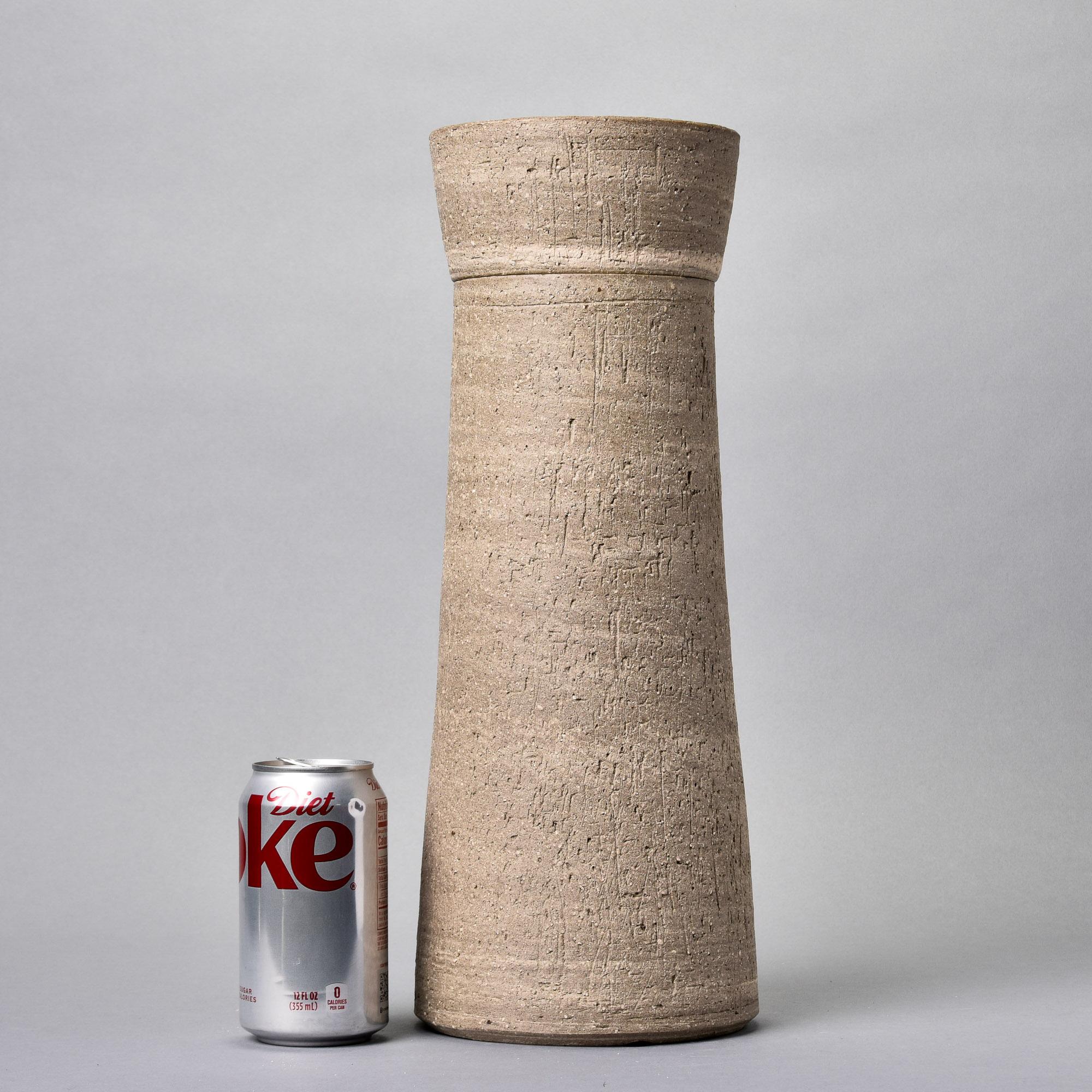 New and found in Germany, this rustic lidded ceramic vessel stands 16” tall. We love the textured surface and matte glaze in earth tones.

Unknown maker. New with no flaws found.  