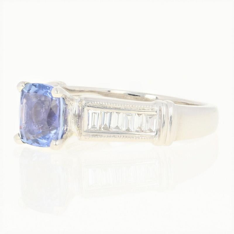 If your bride dreams of a colorfully unique engagement piece, this ring will be a wonderful choice! This NEW 900 platinum ring showcases a radiant tanzanite solitaire held in a raised, four-prong mount above the ring’s milgrain-accented shoulders