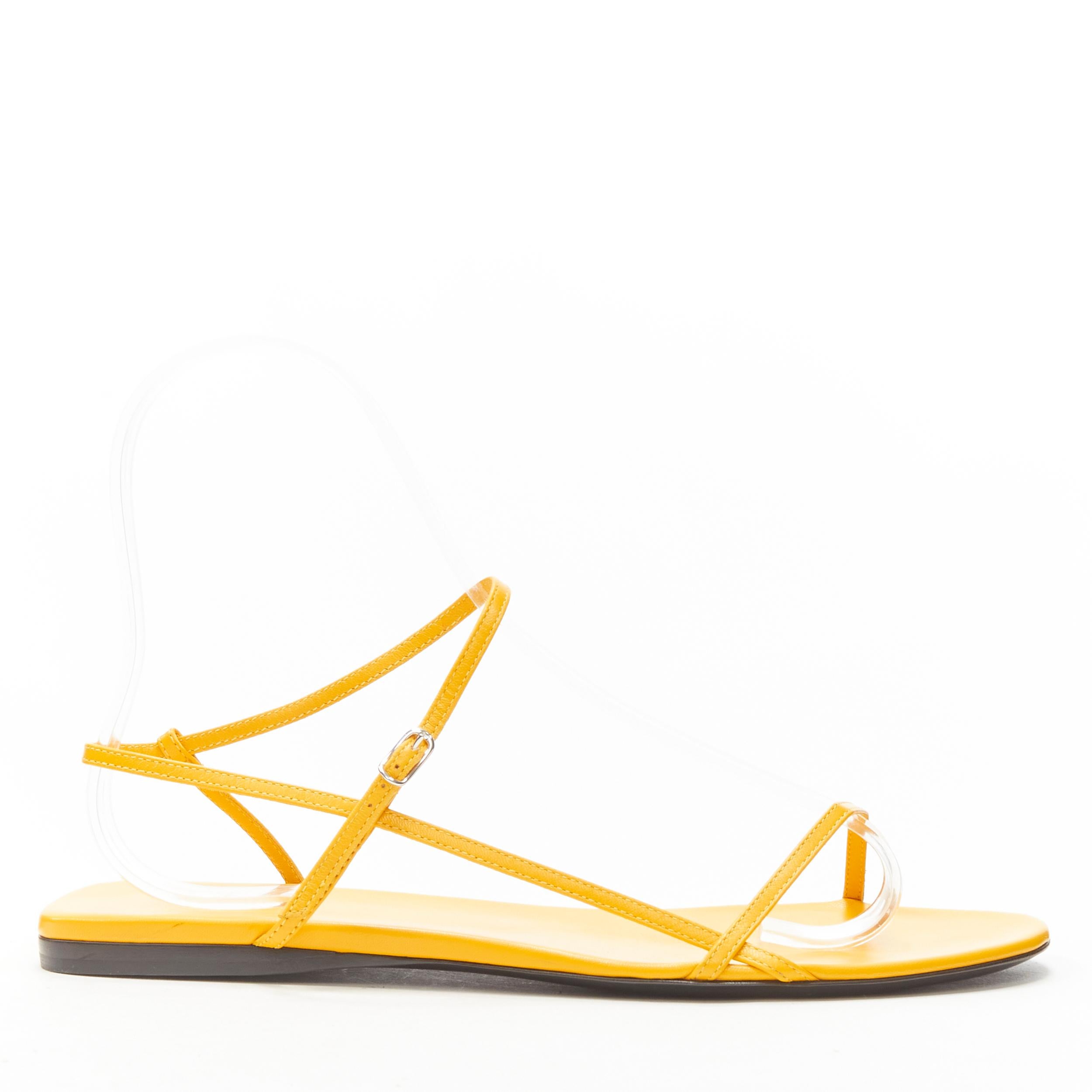 new THE ROW Bare Flat Sandal  mustard yellow kid leather minimal slides EU37.5
Brand: The Row
Designer: Mary Kate and Ashley Olsen
Model: Flat Bare Sandal
Material: Leather
Color: Yellow
Pattern: Solid
Closure: Ankle Strap
Extra Detail: Designer