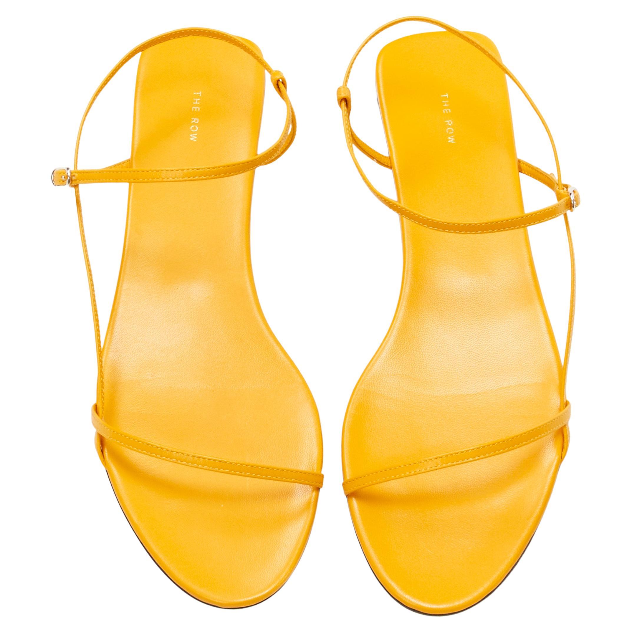 new THE ROW Bare Flat Sandal  mustard yellow kid leather minimal slides EU37.5
Brand: The Row
Designer: Mary Kate and Ashley Olsen
Model: Flat Bare Sandal
Material: Leather
Color: Yellow
Pattern: Solid
Closure: Ankle Strap
Extra Detail: Designer