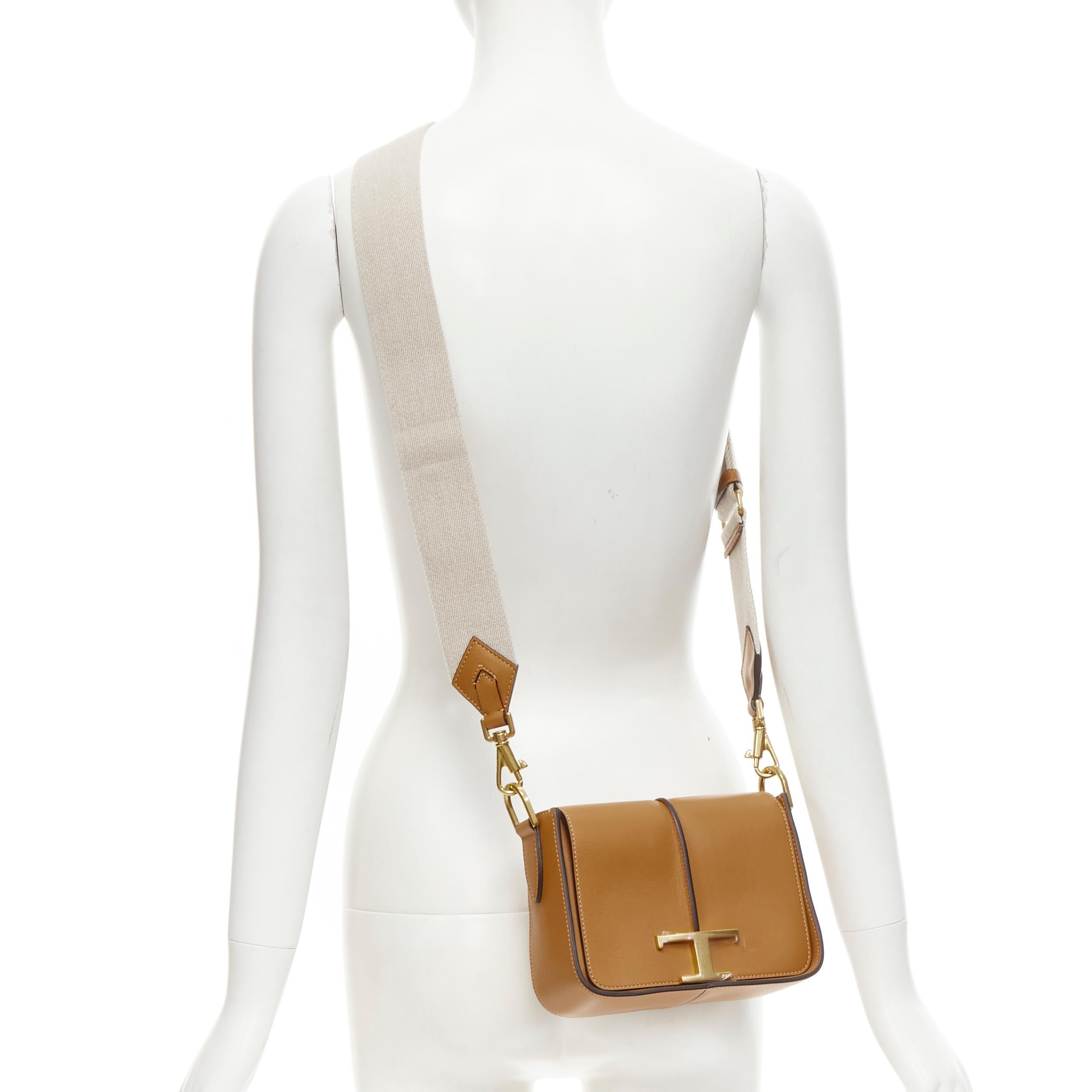 new TOD'S 2022 Timeless gold T brown leather canvas strap mini crossbody bag 
Reference: JOMK/A00067 
Brand: Tod's 
Model: Timeless Crossbody 
Material: Leather 
Color: Brown 
Pattern: Solid 
Closure: Flap 
Extra Detail: Flap bag in refined leather