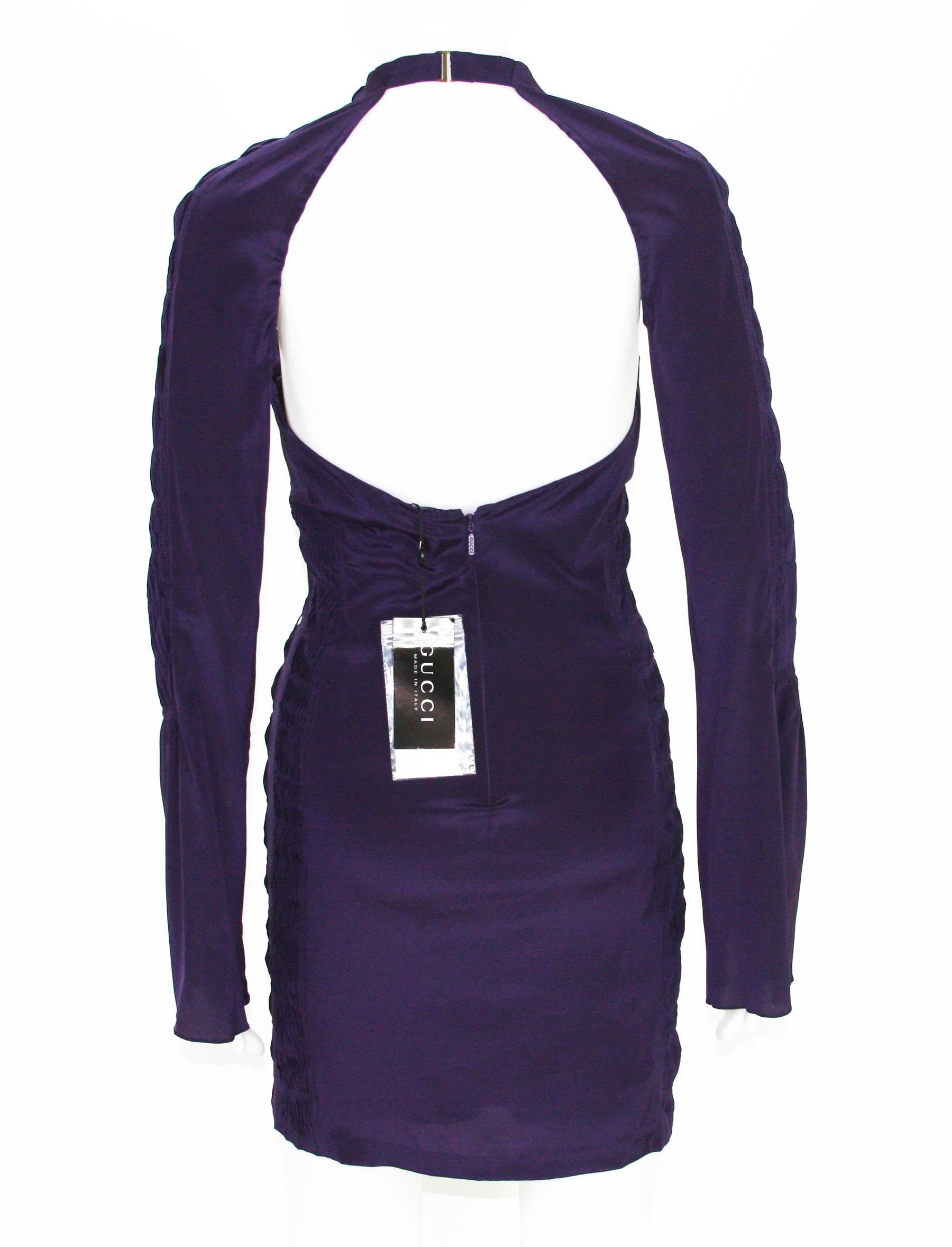 New Tom Ford for Gucci Plunging Backless Mini Sexy Dress
S/S 2004 Collection
Designer sizes available - 38 and 44
90% Silk, 10% Spandex; Deep Purple Color, Cut-Out Detail, Bell Sleeve, Fully Lined, Open Back, Gathered Panels, Zip Closure.
Made in