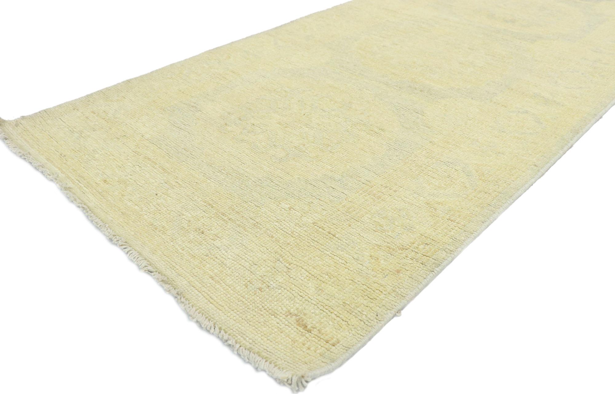 80217, new transitional Khotan style hallway runner with pomegranate design. Blending elements from the modern world with light and airy colors, this hand knotted wool transitional Khotan style runner charms with ease. The abrashed field features a