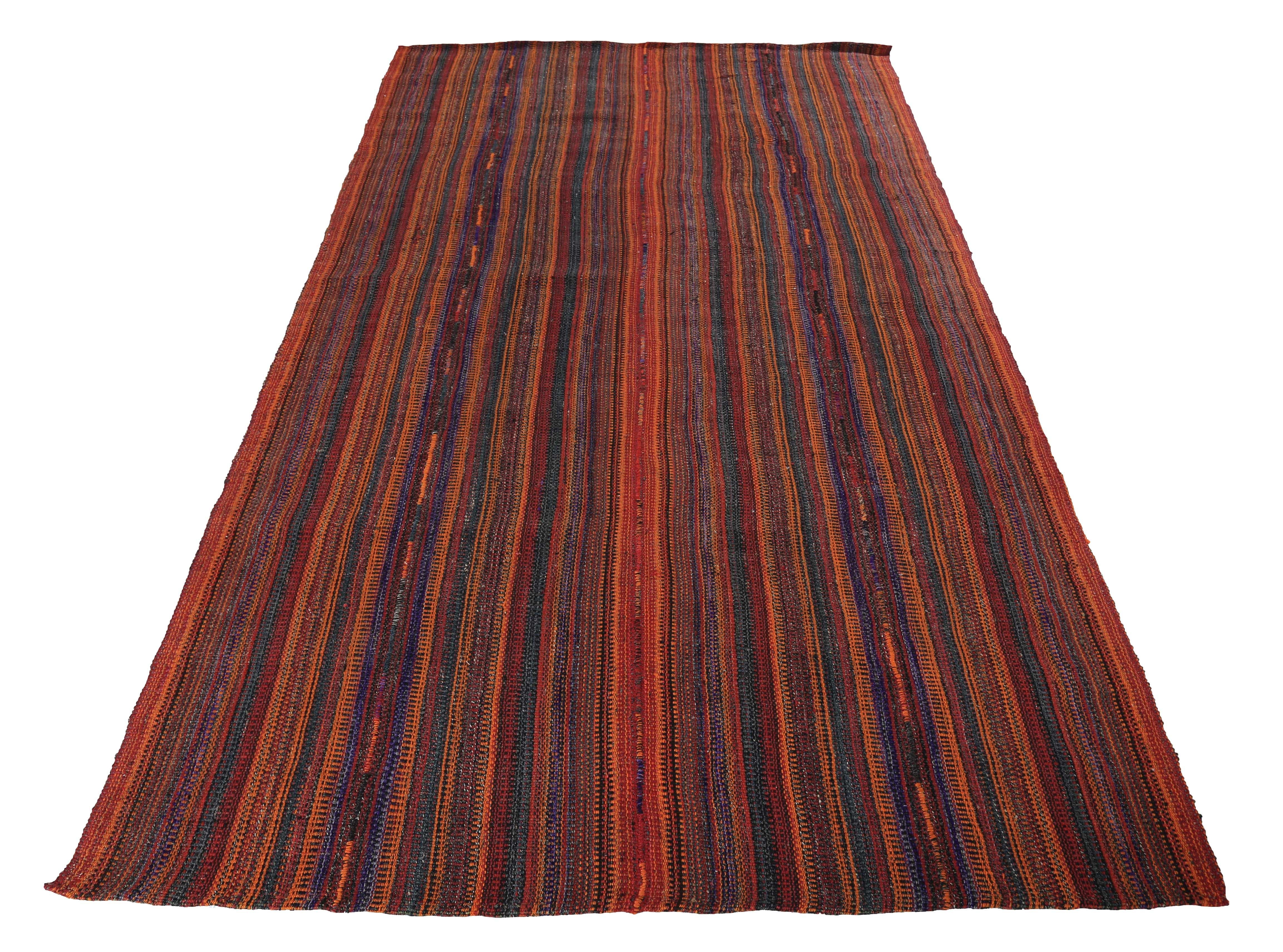 Turkish rug handwoven from the finest sheep’s wool and colored with all-natural vegetable dyes that are safe for humans and pets. It’s a traditional Kilim flat-weave design featuring a tribal design field with black and red stripes. It’s a stunning