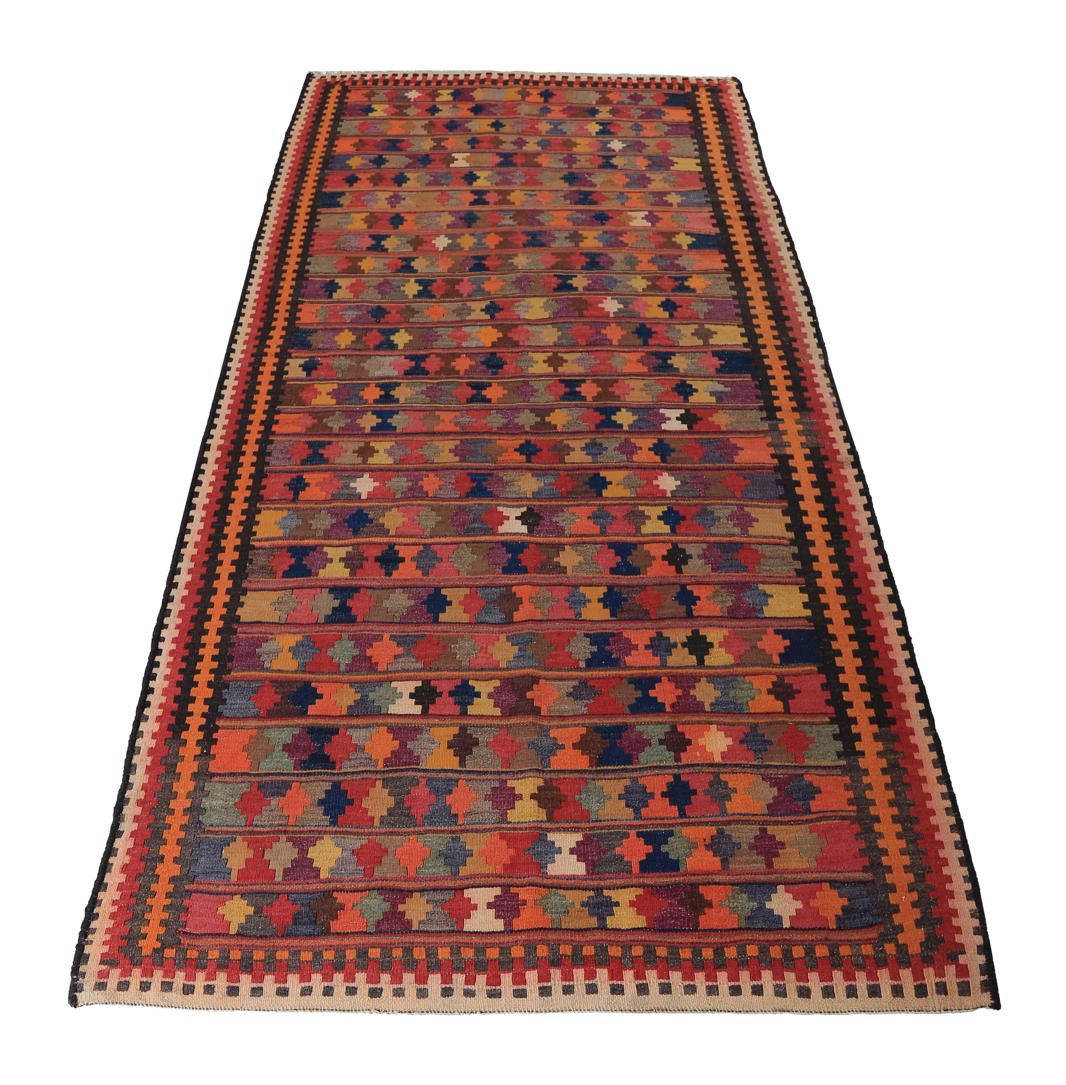 Turkish rug handwoven from the finest sheep’s wool and colored with all-natural vegetable dyes that are safe for humans and pets. It’s a traditional Kilim flat-weave design featuring a colorful mix of geometric and tribal details. It’s a stunning